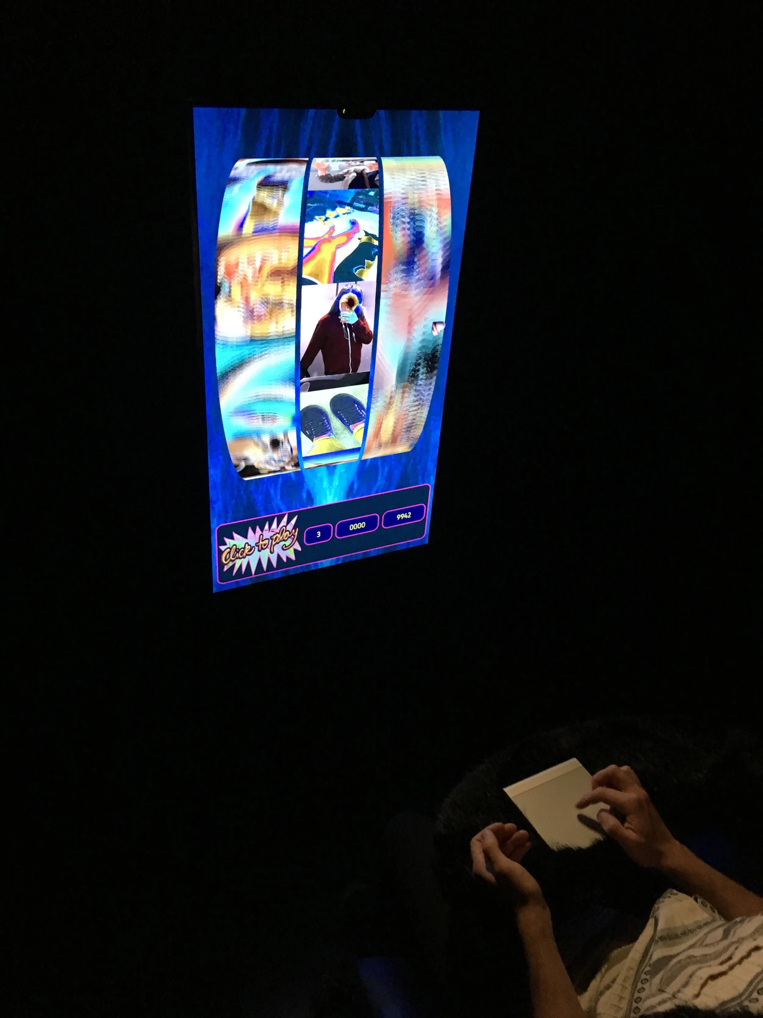 Install shot of audience member playing 'Entering the Machine Zone II' (2018) Katriona Beales, part of HOOKED (2018) at Science Gallery London