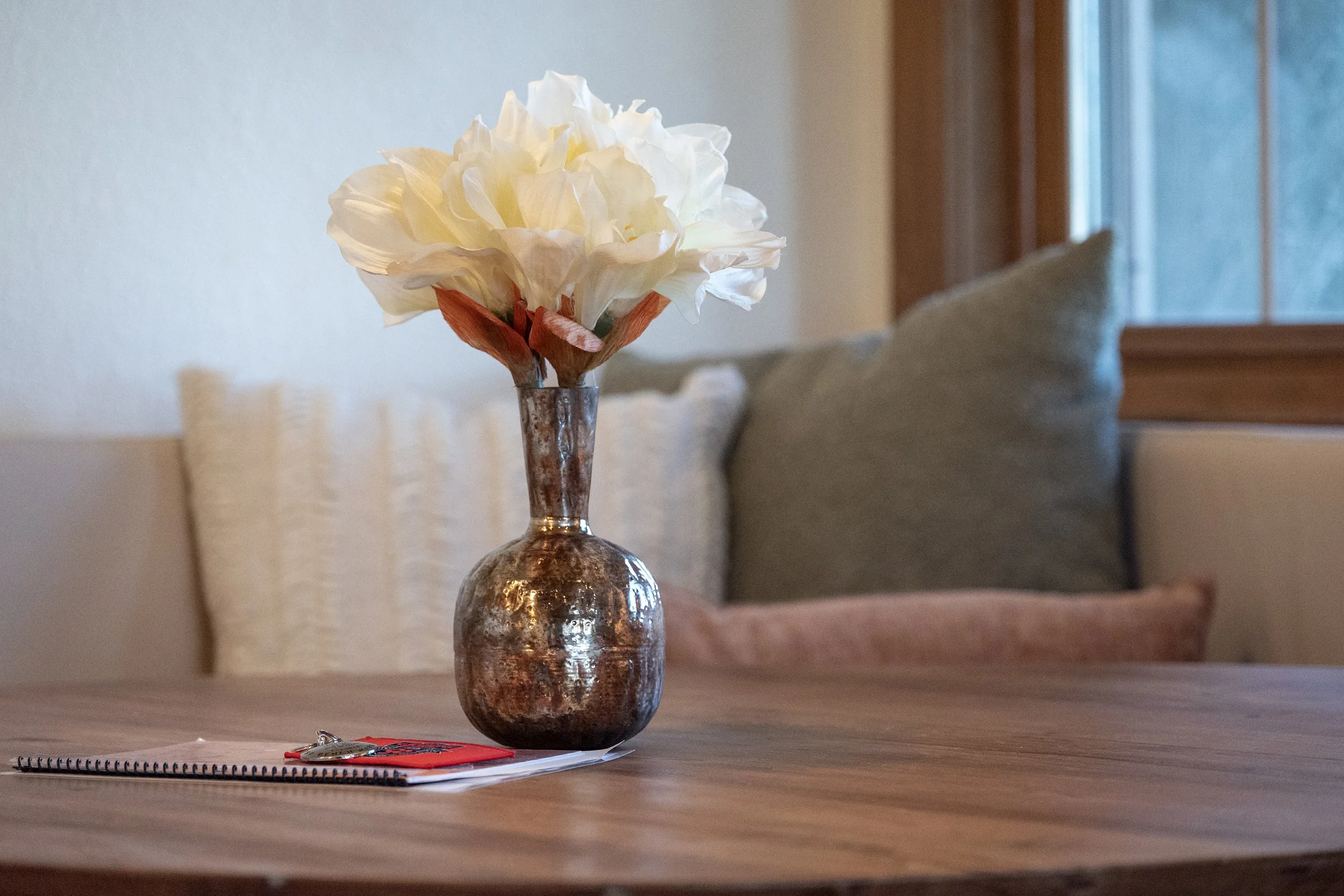 A warm welcome: decorative blooms and the guest guidebook create an inviting touch in the breakfast nook.