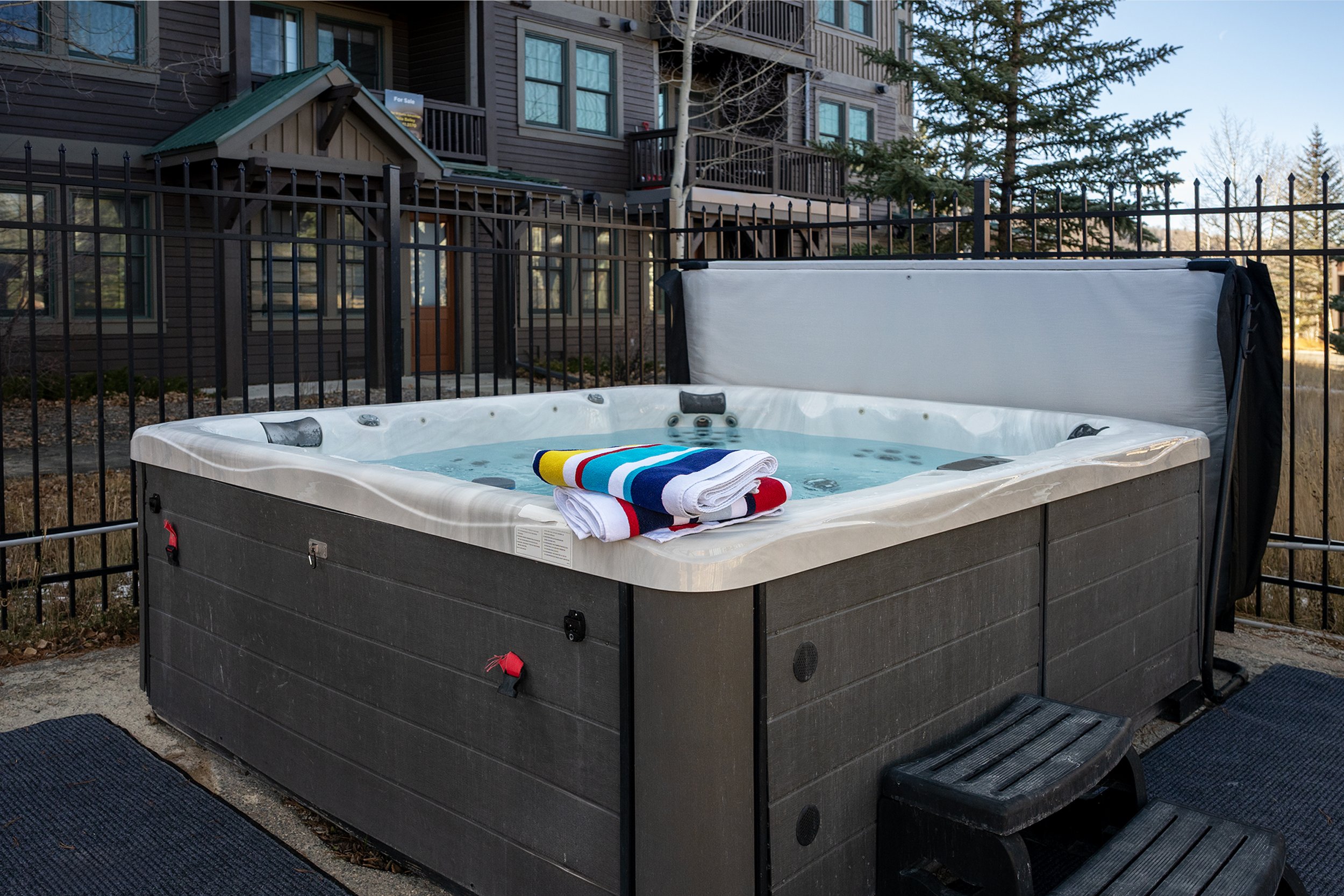 Outdoor hot tub steps from the condo, with fresh towels provided for an easy soak after a day of adventure.