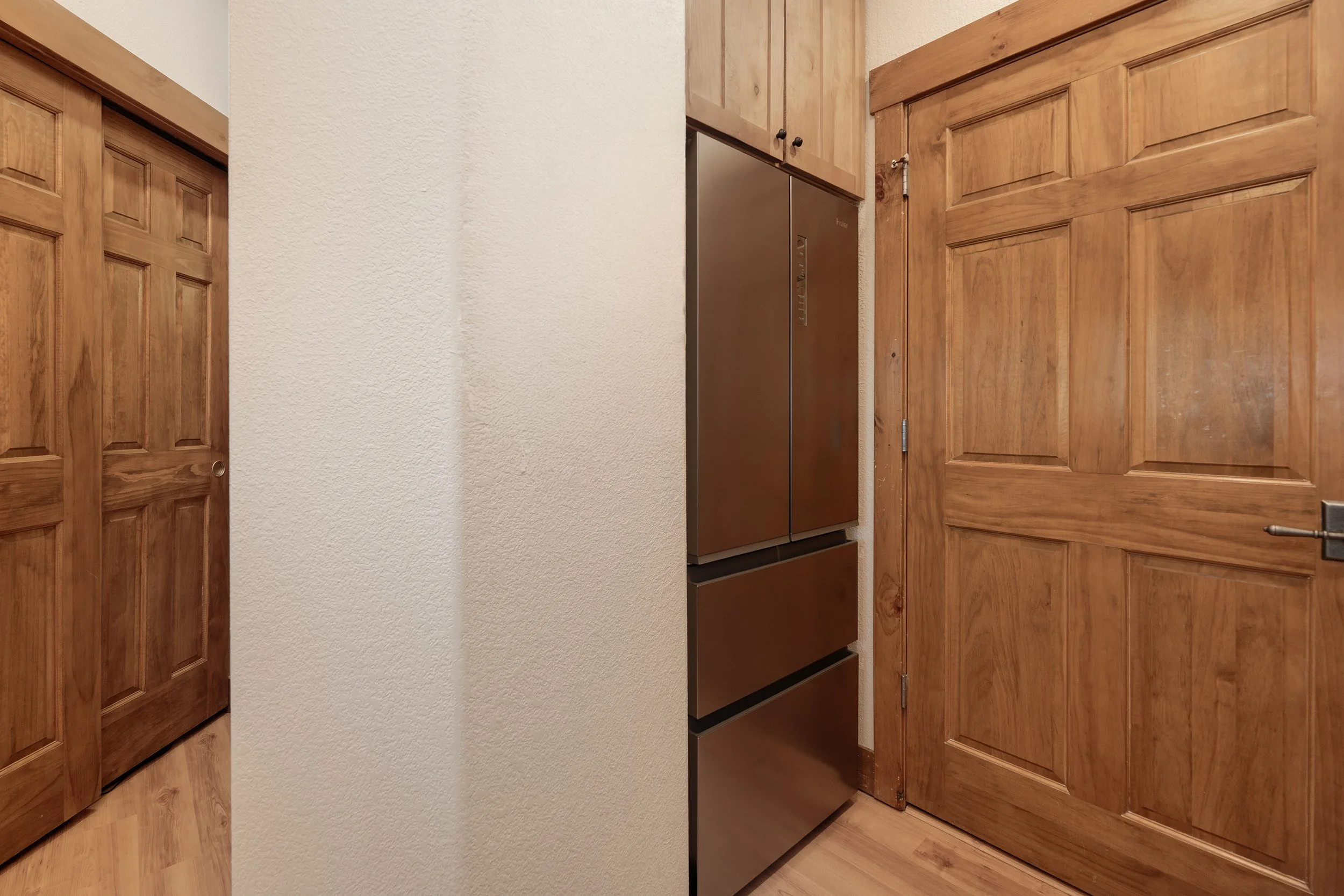 Brand-new full-size stainless fridge with double freezer drawers.