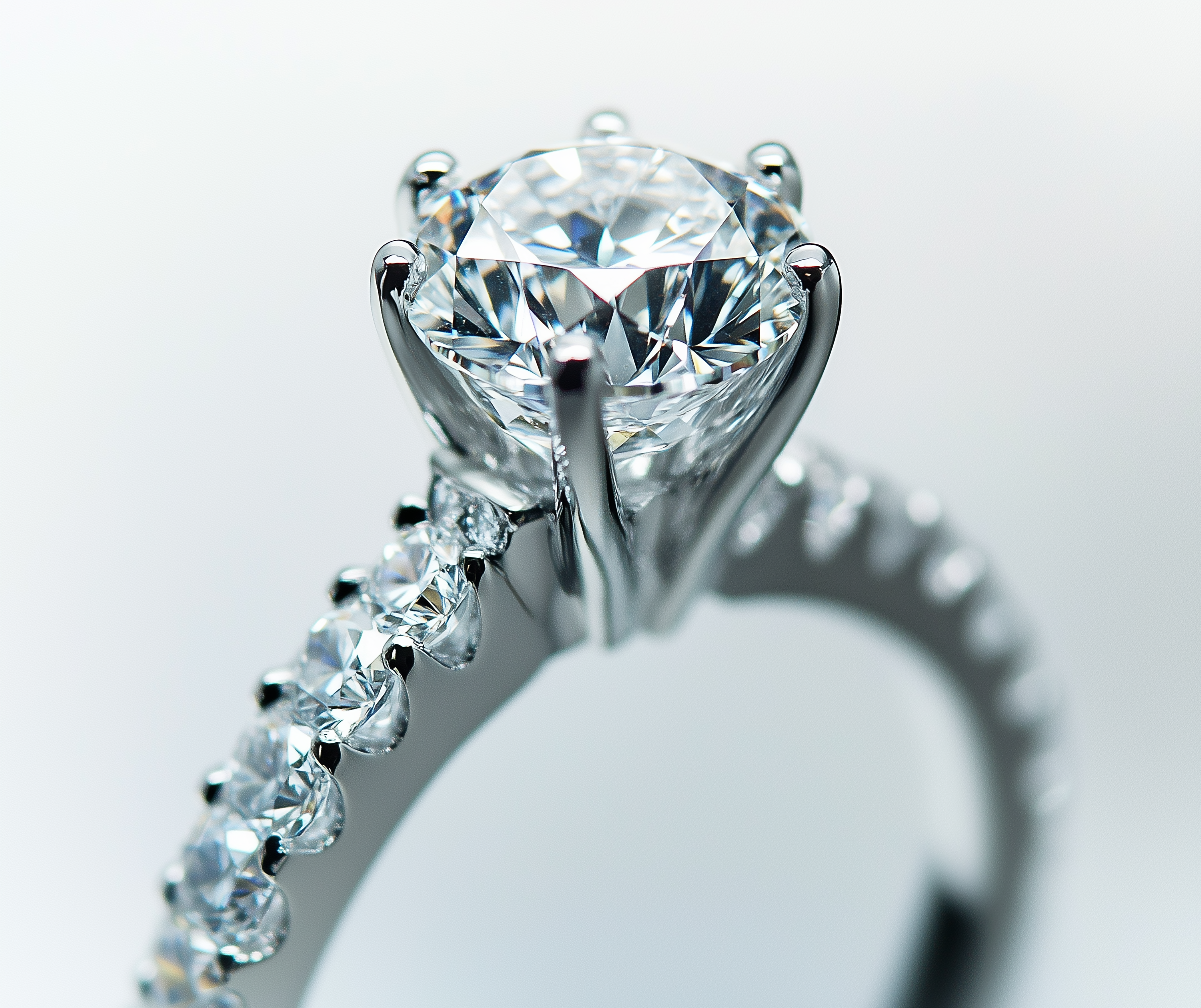 Ein funkelnder Diamant in einer Fassung, aufgenommen in Nahaufnahme gegen einen hellen Hintergrund.