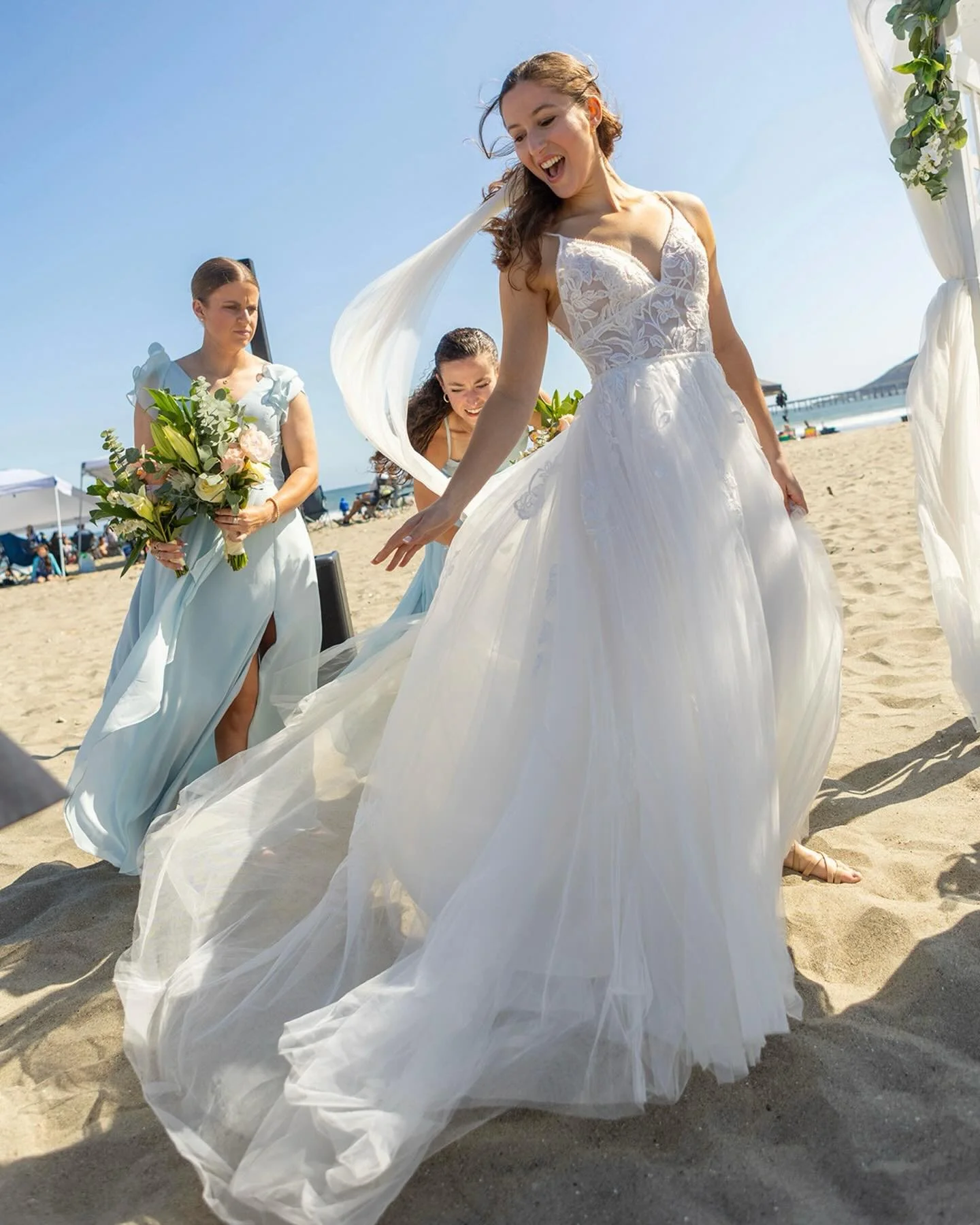 Jaqueline and Abrar&rsquo;s ceremony at Avila Beach came with a little coastal drama. Gusty ocean winds caught Jaqueline&rsquo;s long veil and sent it dancing through the air! Her bridesmaids had her back and were quick to get it under control for th