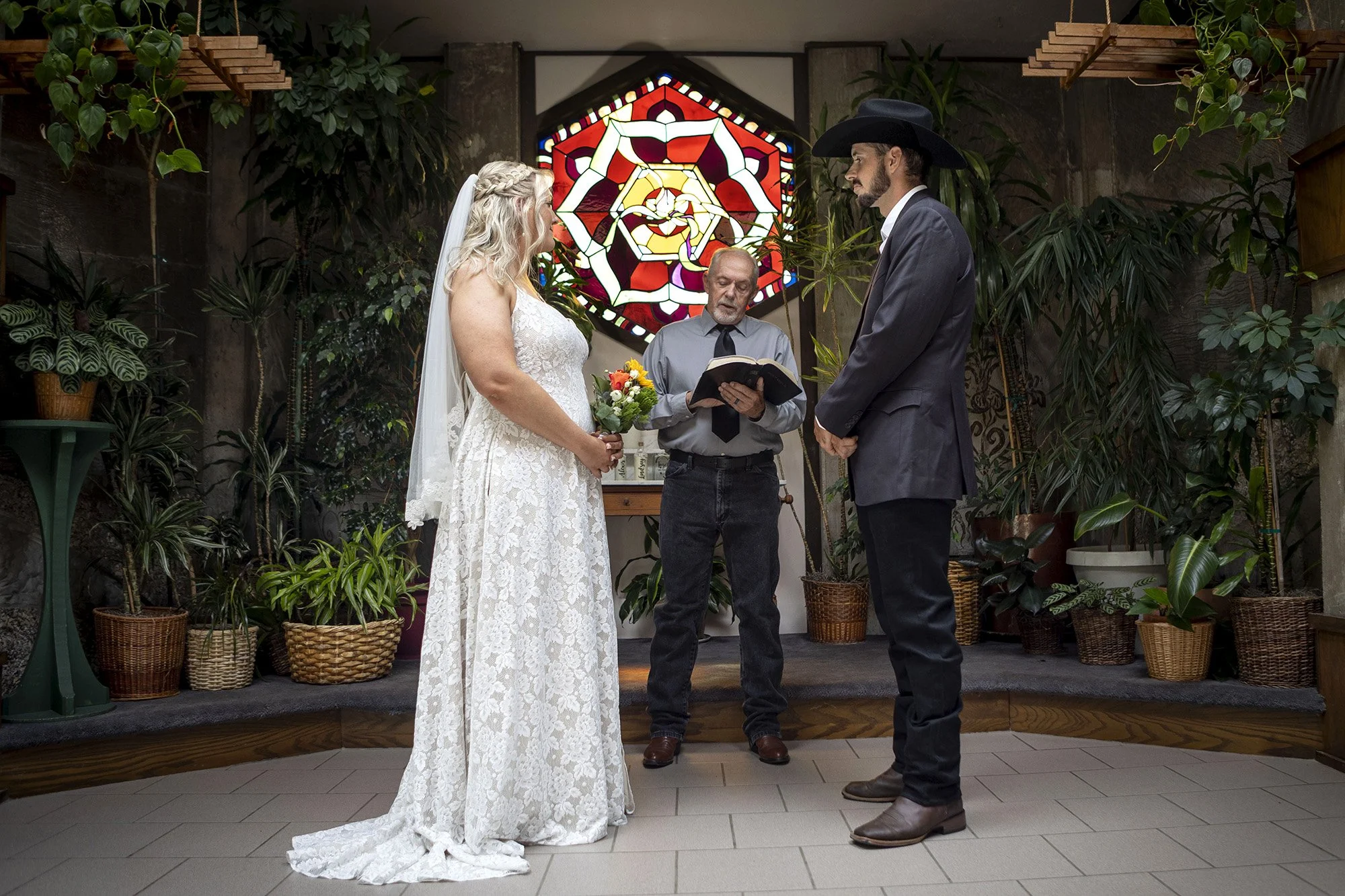 Bride and groom getting married in the garden chapel at Coalesce Bookstore