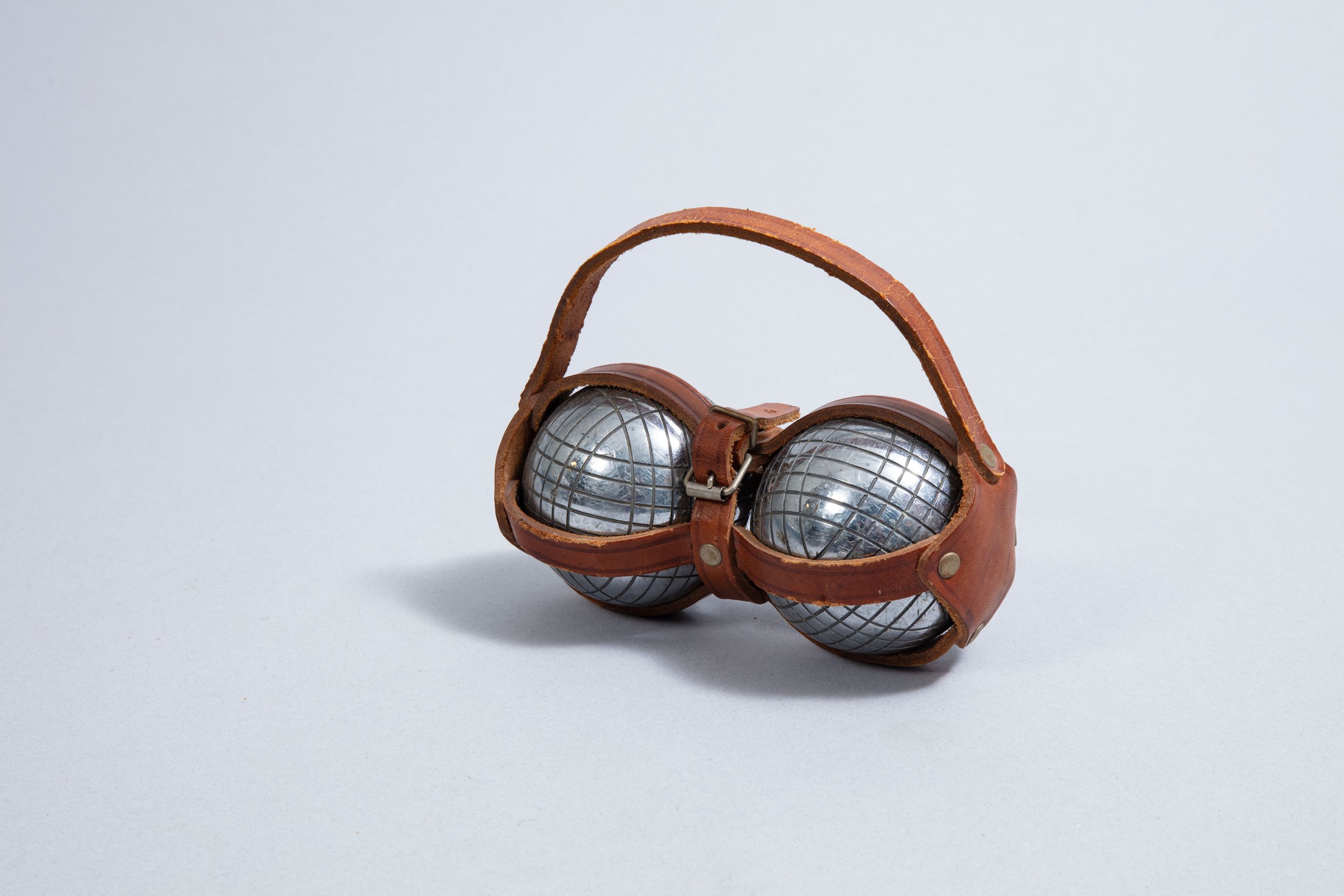 A set of two pétanque balls in a leather case