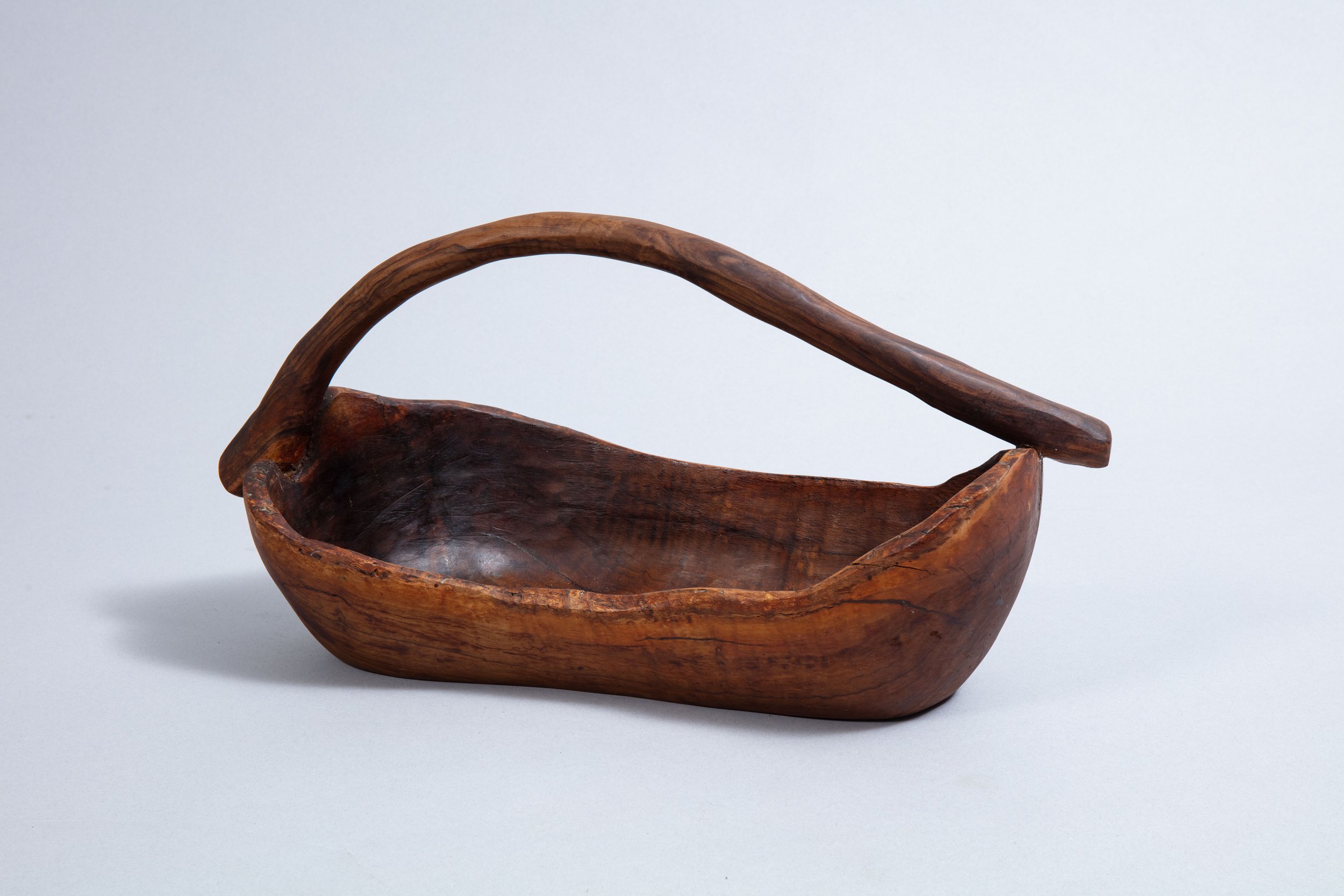 Bowl with a handle carved from olive wood