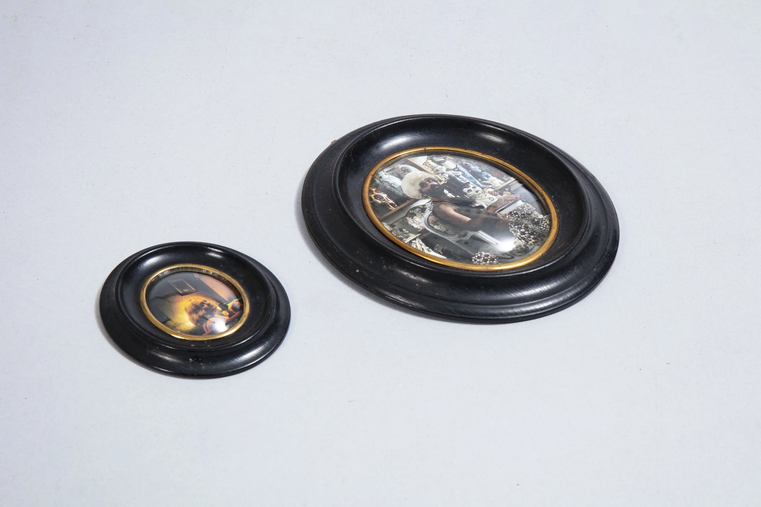 A pair of frames, circa 1900, with concave glass