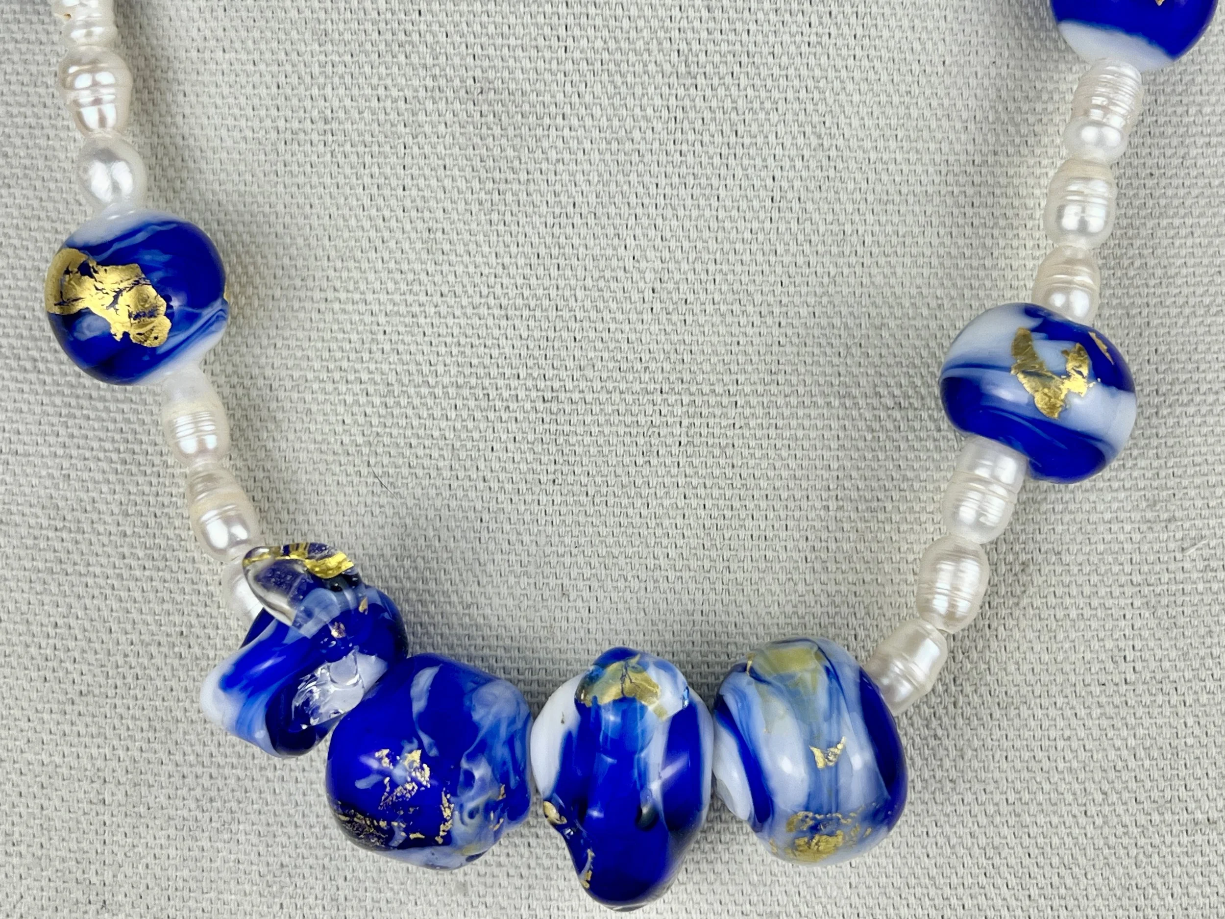 Ocean Soul Necklace featuring handmade cobalt blue and white lampworked glass beads with 24K gold foil accents, paired with freshwater pearls.