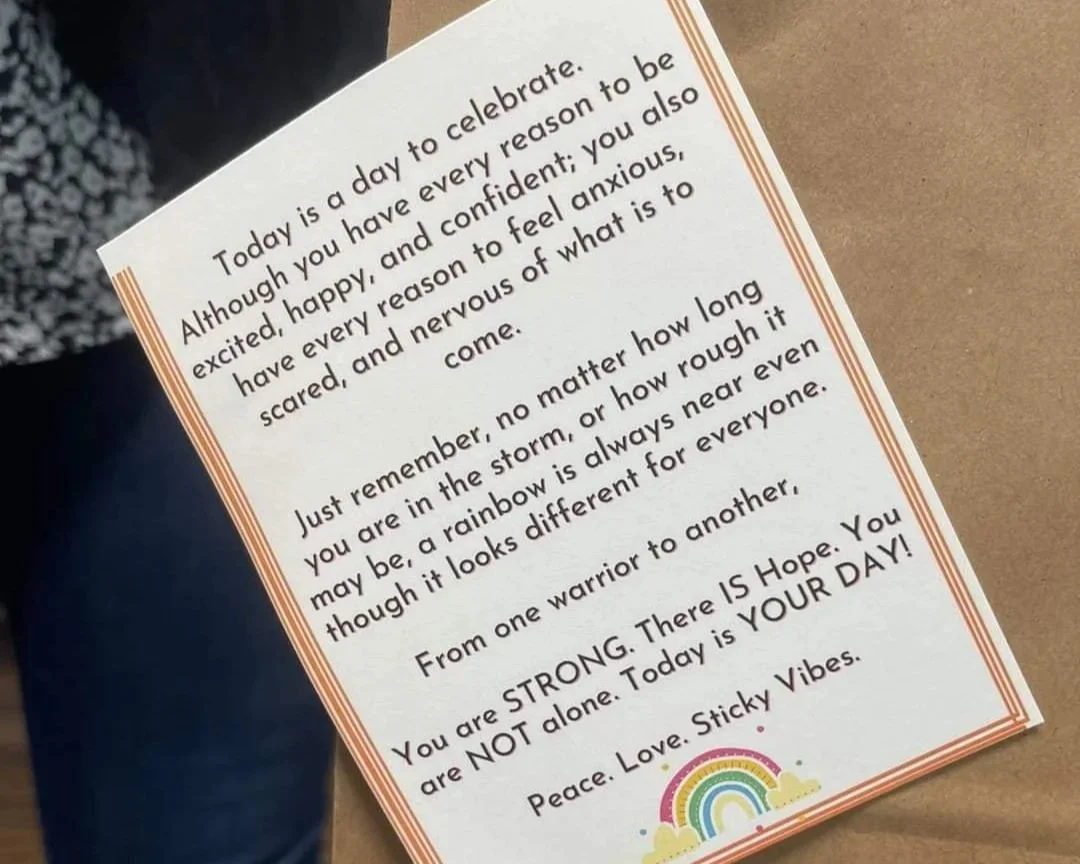 A printed note with positive affirmations and encouragement, decorated with a small rainbow illustration at the bottom right corner.