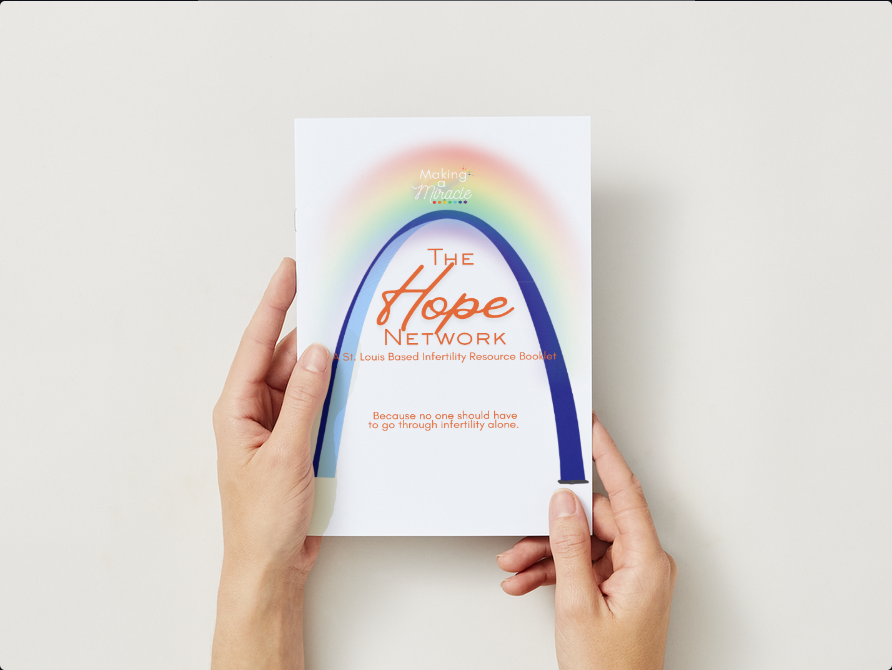 Person holding a book titled "The Hope Network" with a rainbow graphic on the cover.