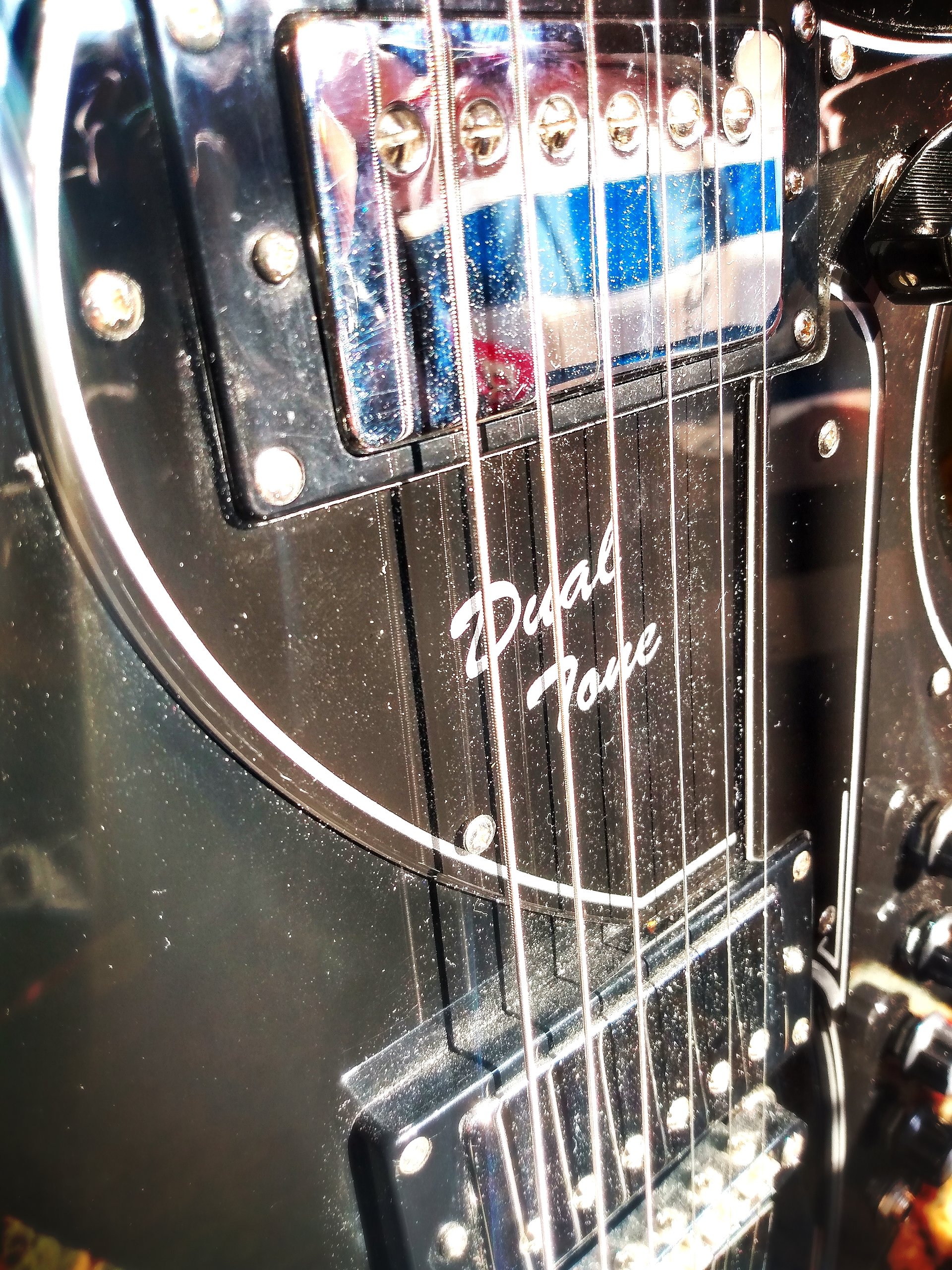Eastwood (Supro branded) Dual Tone. Custom, re-designed pickguard. Chrome body binding. NOS National/ Valco tailpiece. Supro tuner buttons. D'Angelico trussrod cover.