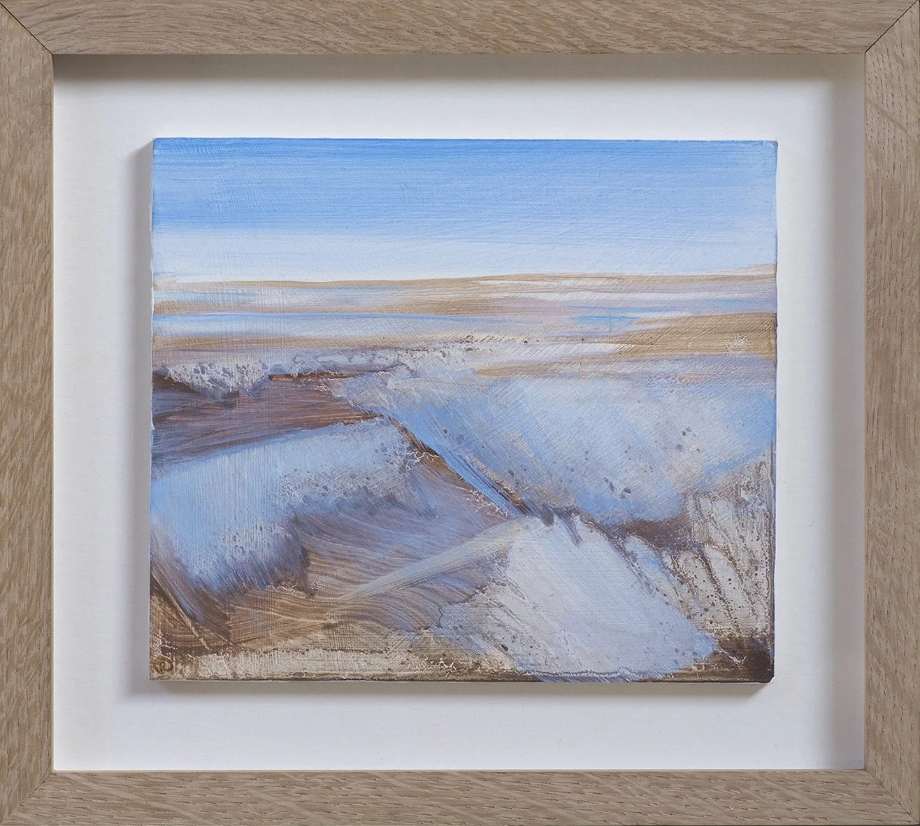Painting of a seascape with waves crashing on the shore under a blue sky, framed in light wood.