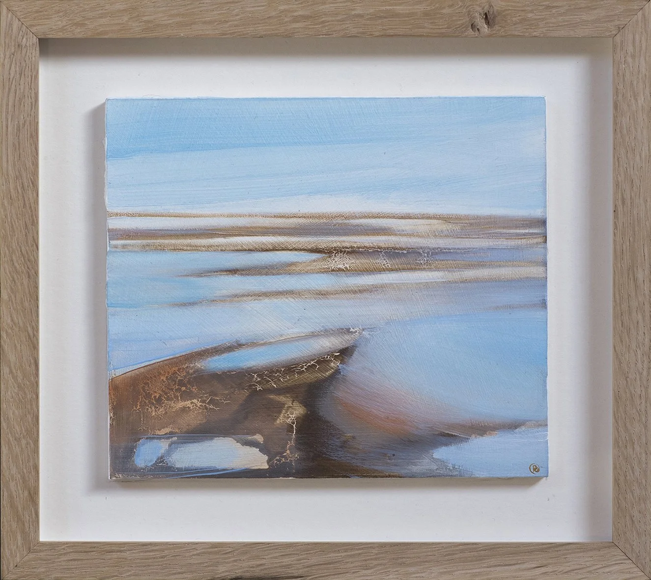 Abstract landscape painting of a coastal scene with blue sky, sandy formations, and water, framed in wood.