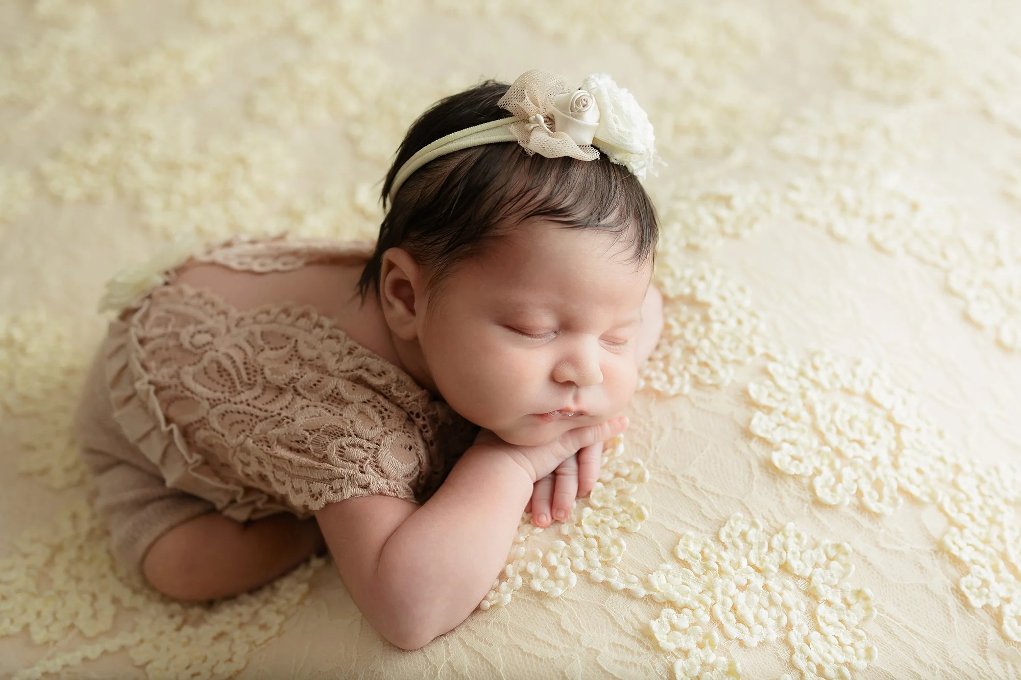 Newborn baby girl curled up in a safe and comfortable pose in my Washington, DC studio.