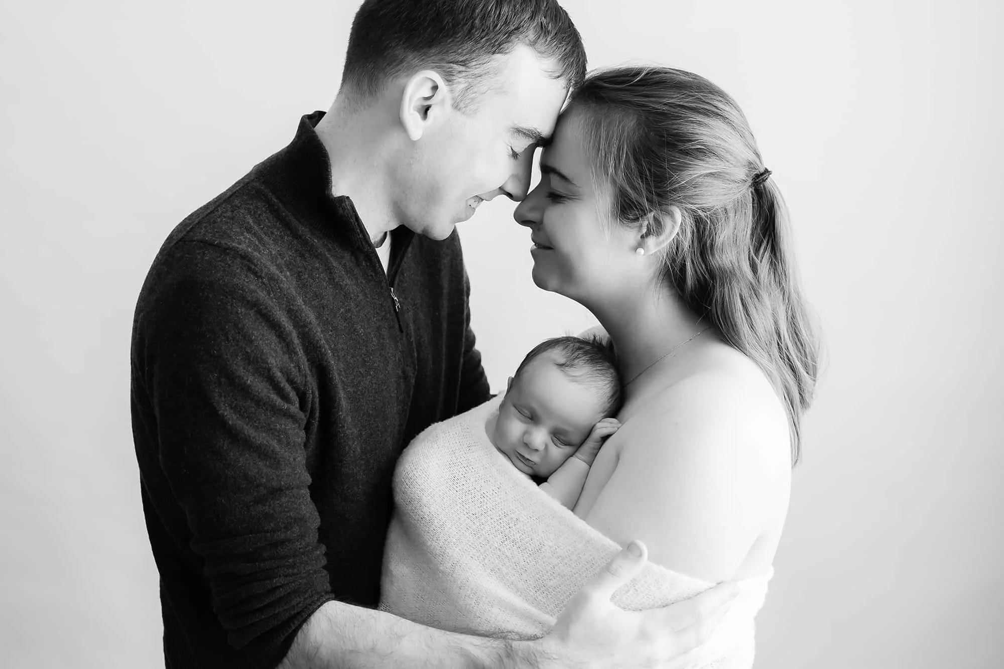 Loving parents nuzzling with newborn baby, Manassas, Virginia