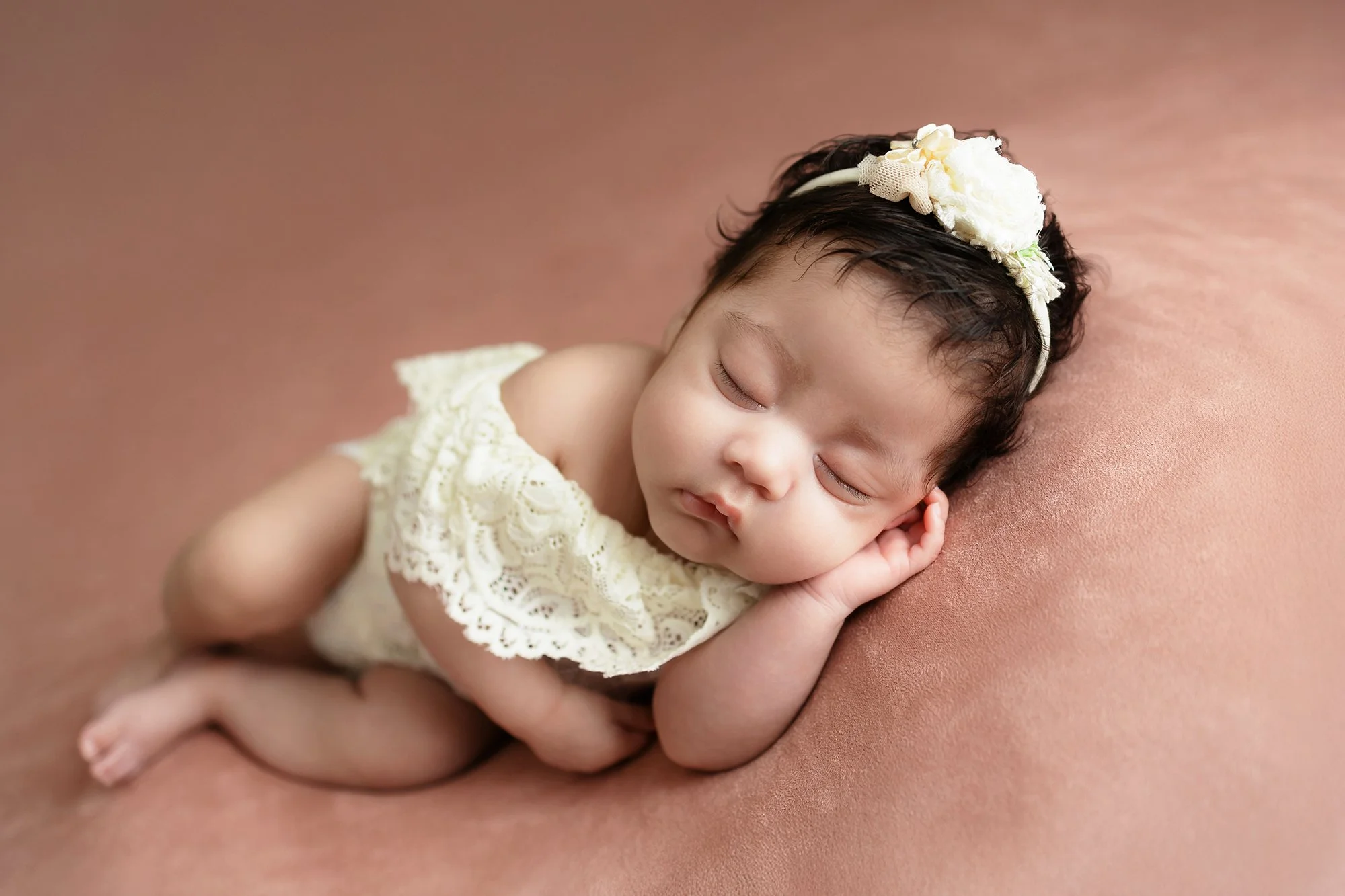 Posed newborn baby girl portrait by a professional photographer in Washington, DC