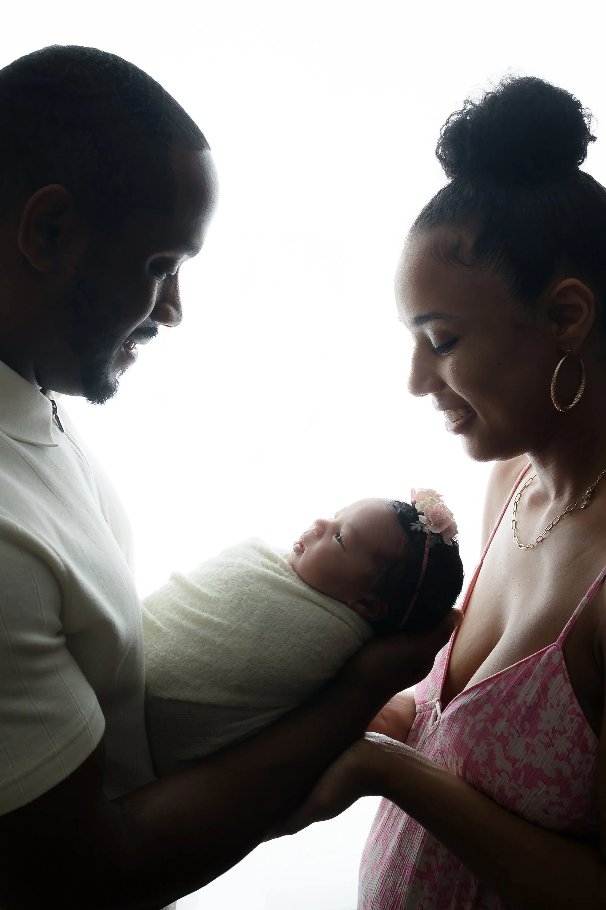 New family of three with newborn baby girl posing in northern Virginia photography studio