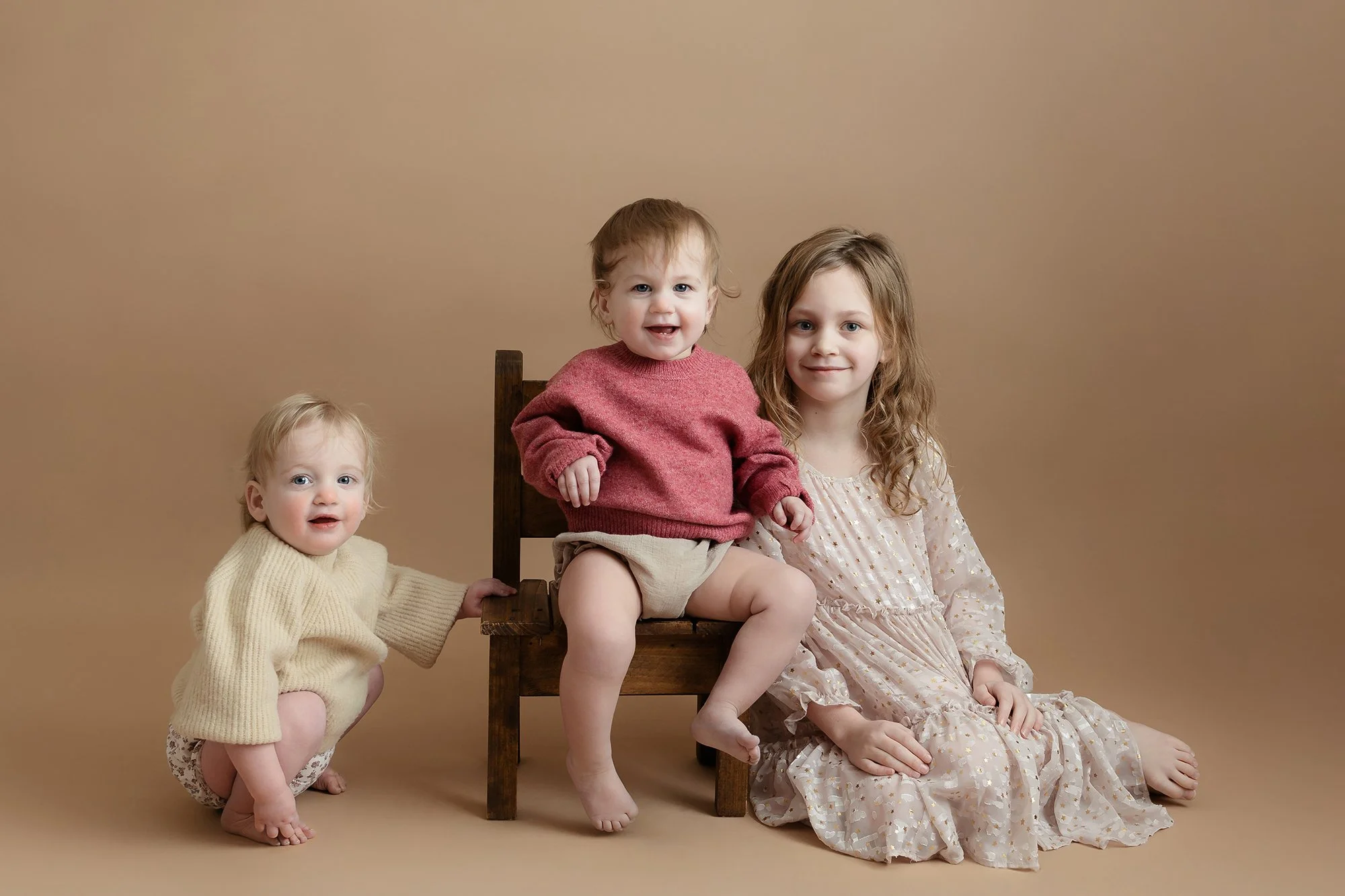 Heartfelt studio portrait of siblings, capturing their unique bond and genuine smiles.