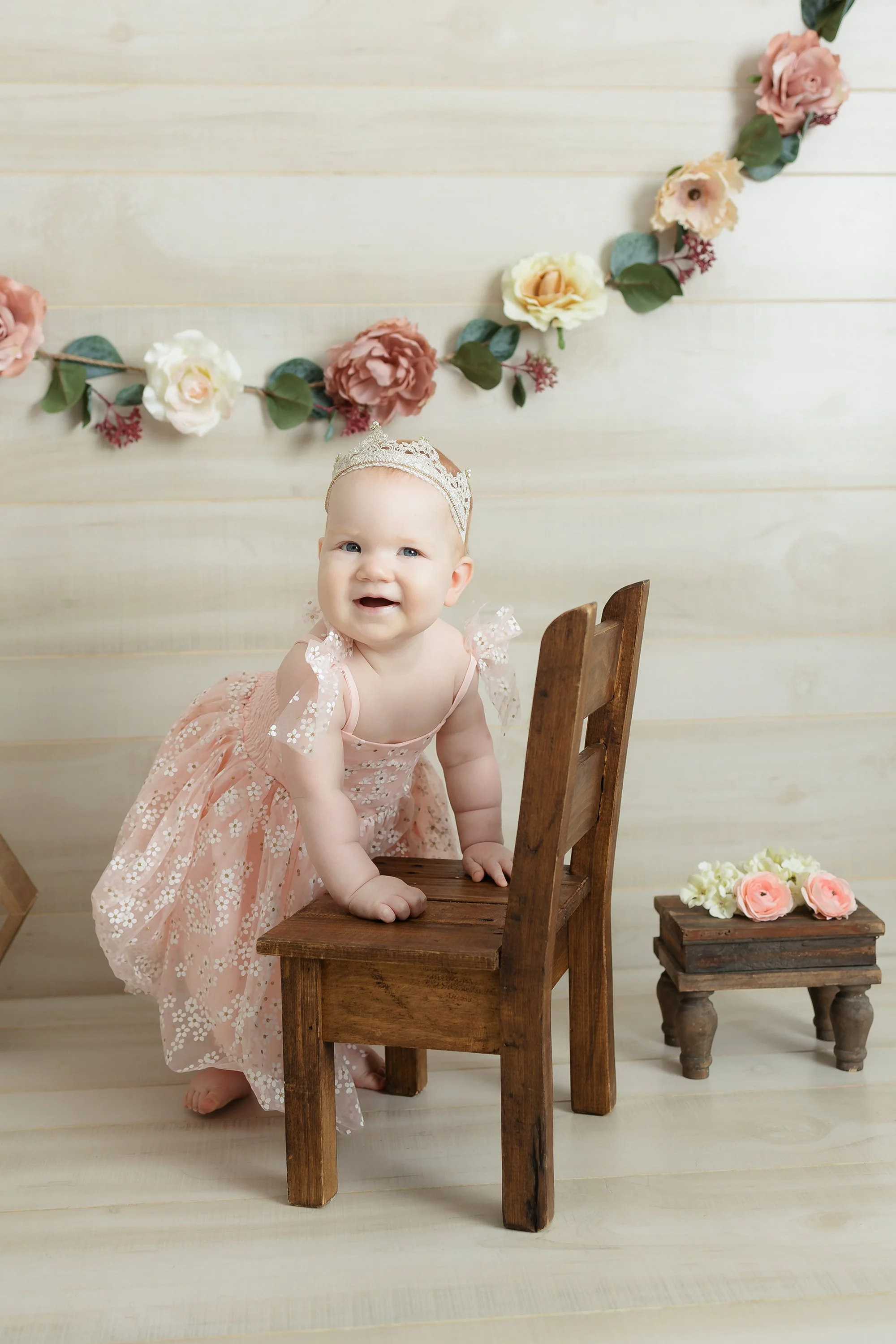 One-year-old baby girl standing and smiling during her milestone session in Alexandria, Virginia.