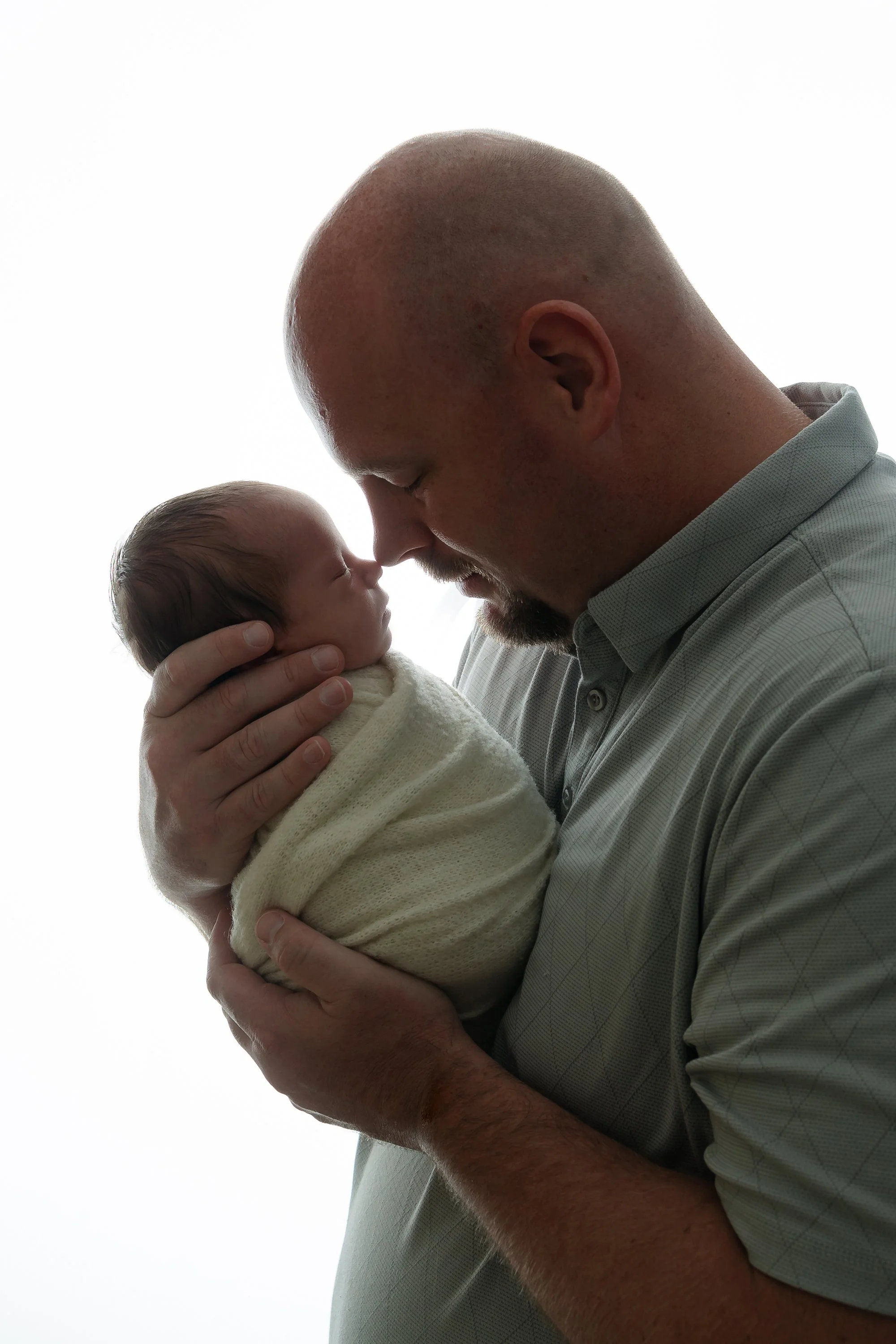 Newborn baby posing with dad