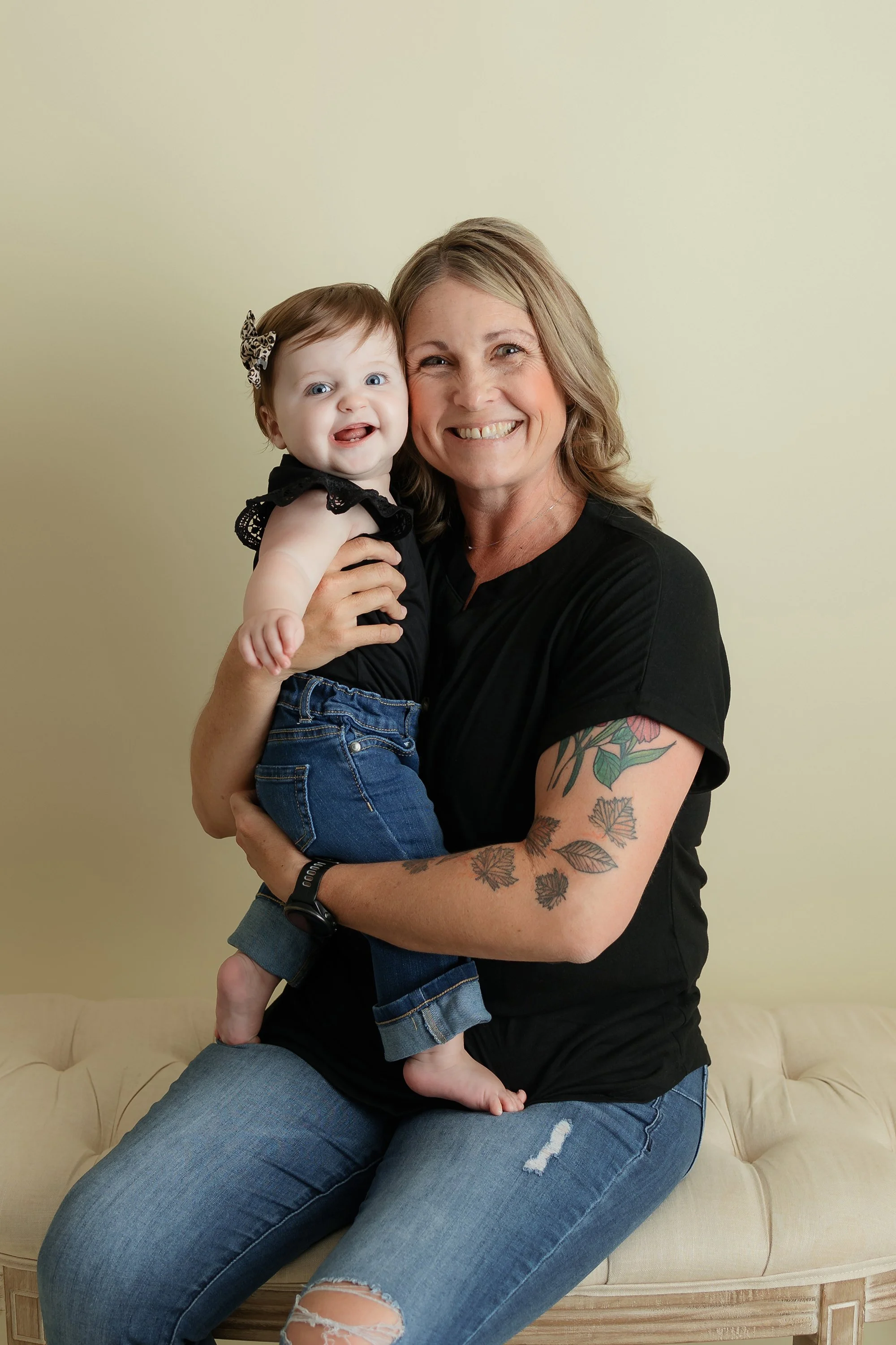 Mother and one year old daughter happy and smiling for their family portrait.