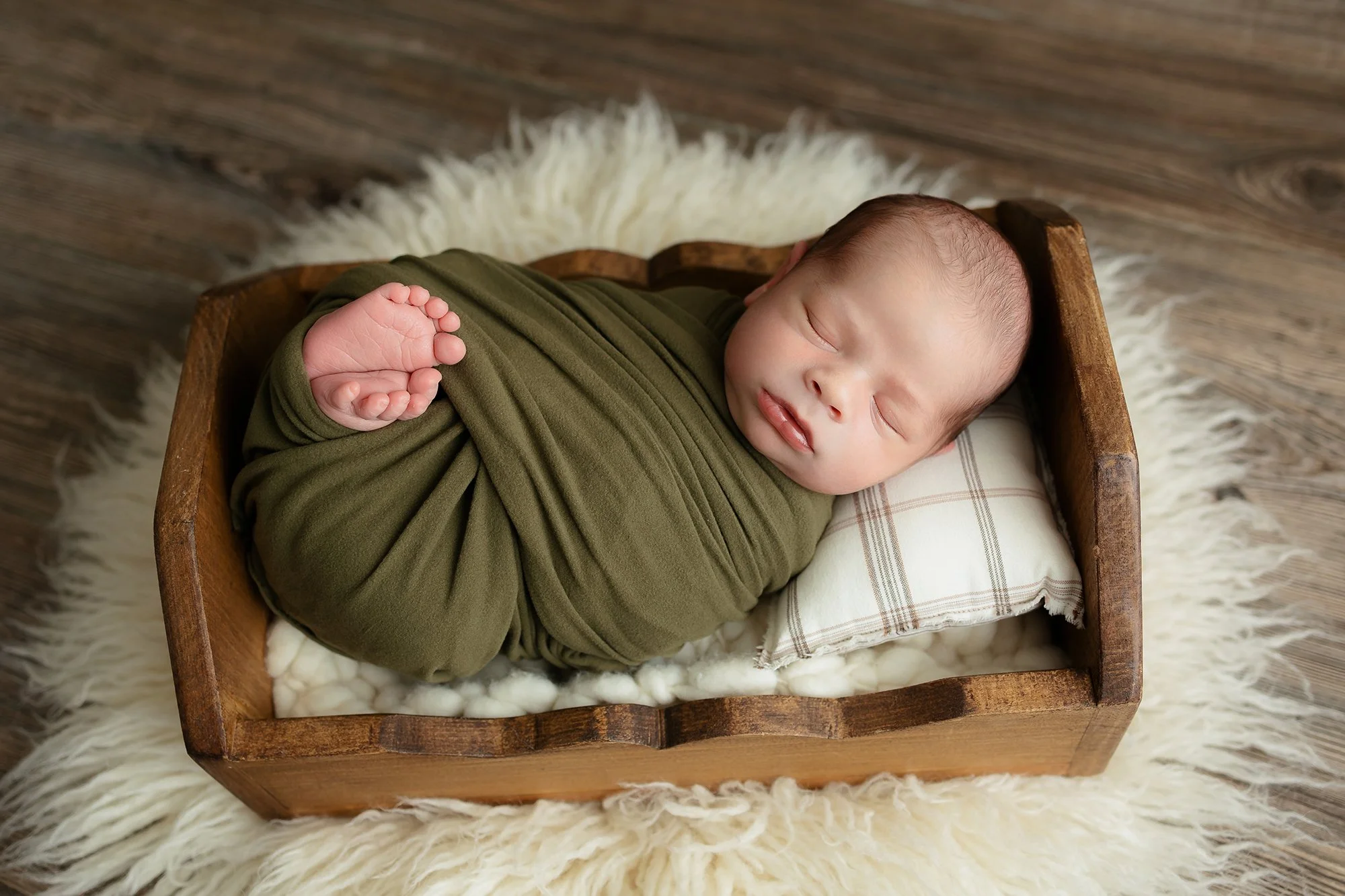 Newborn baby boy posing for a photo