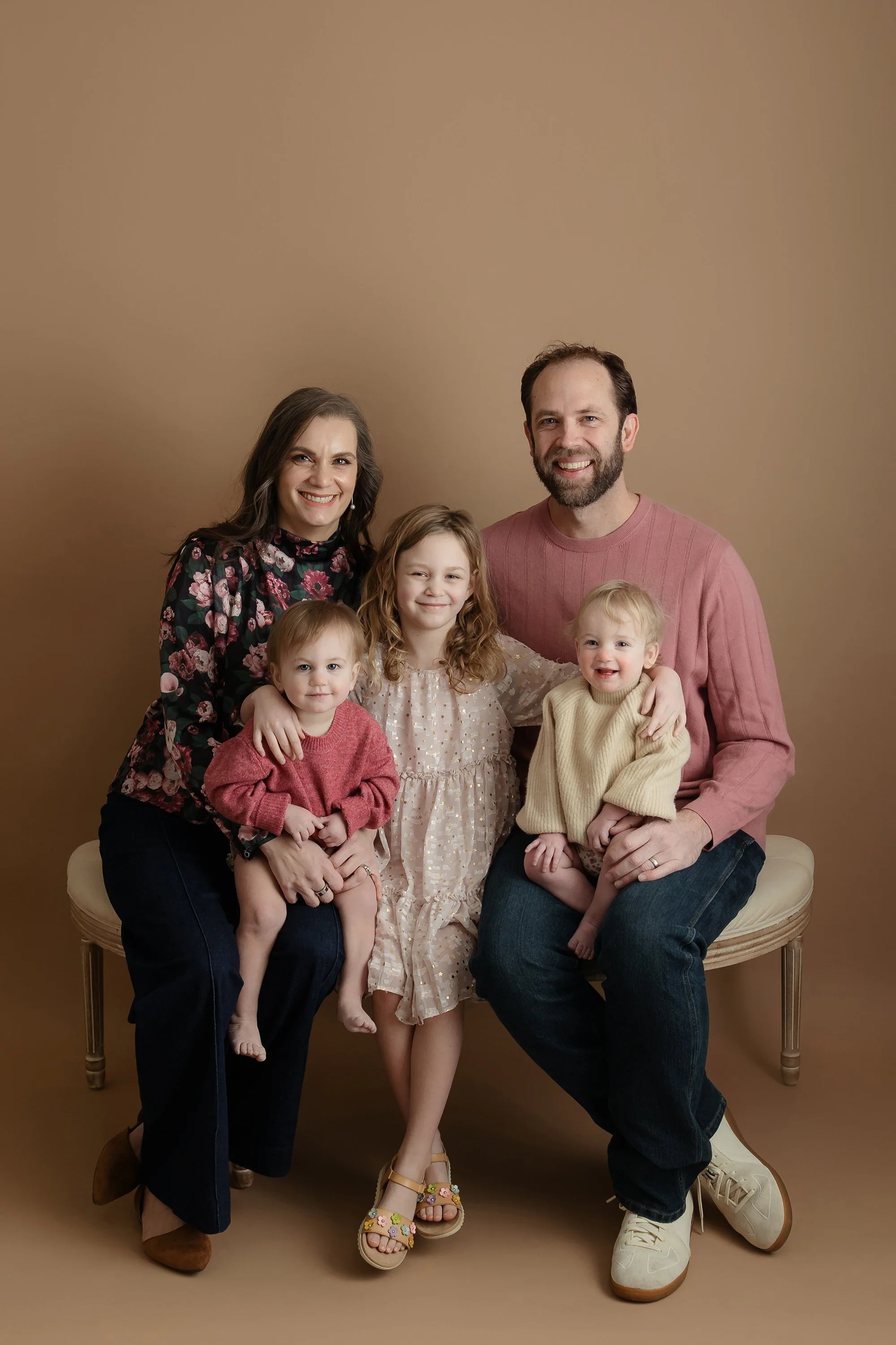 Modern studio photography of a family connecting and laughing naturally, captured by RA Photography.