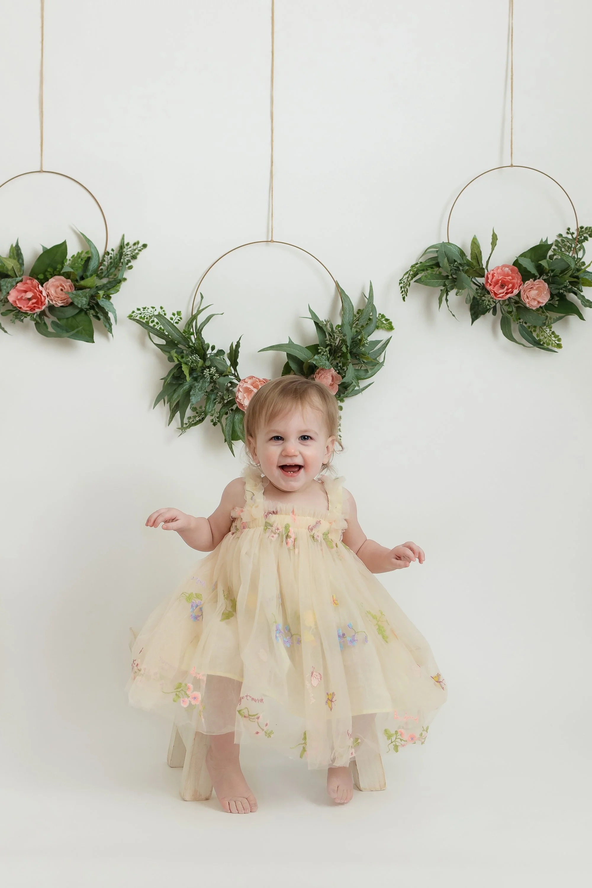 One year portrait and happy baby girl posing in my northern Virginia studio.
