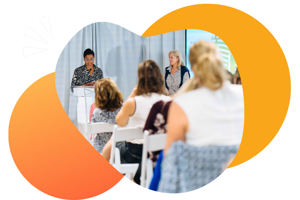A woman speaking at a podium learning how to public speak in front of an audience