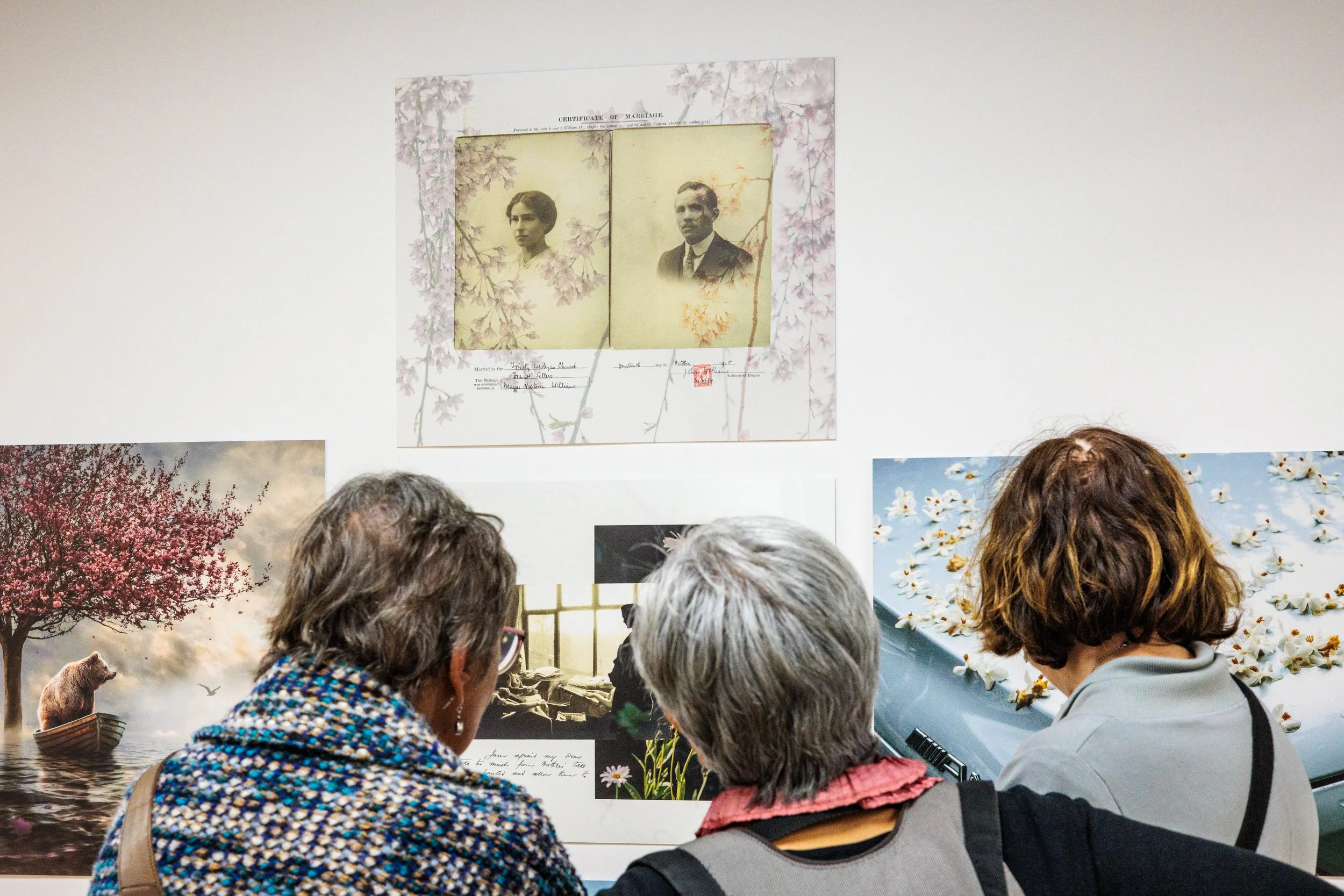 People viewing artwork at an art exhibit.