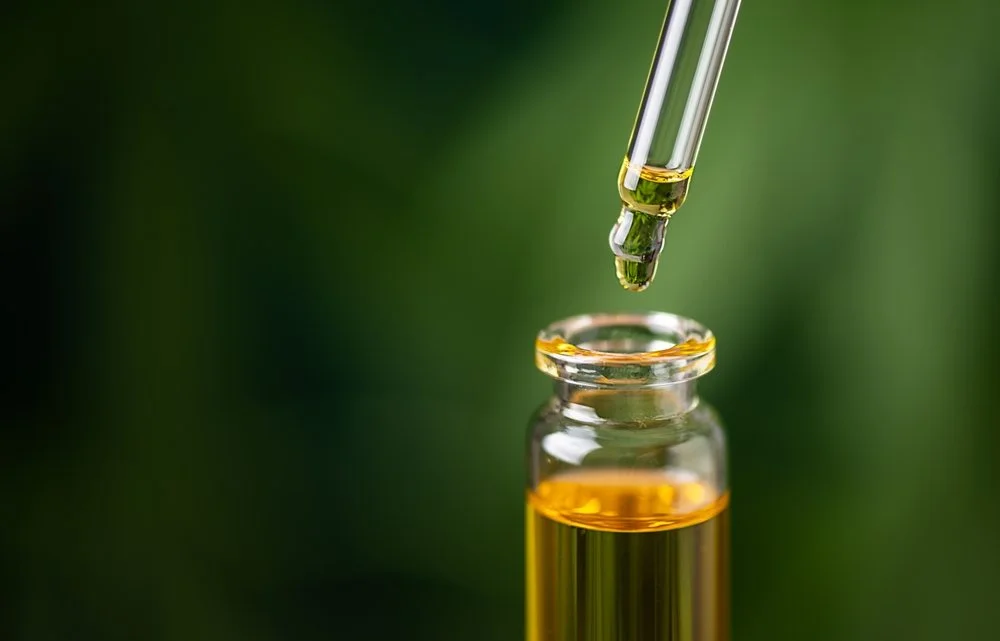 CBD hemp oil on cannabis leaf background. CBD oil extract | Safer Sacramento