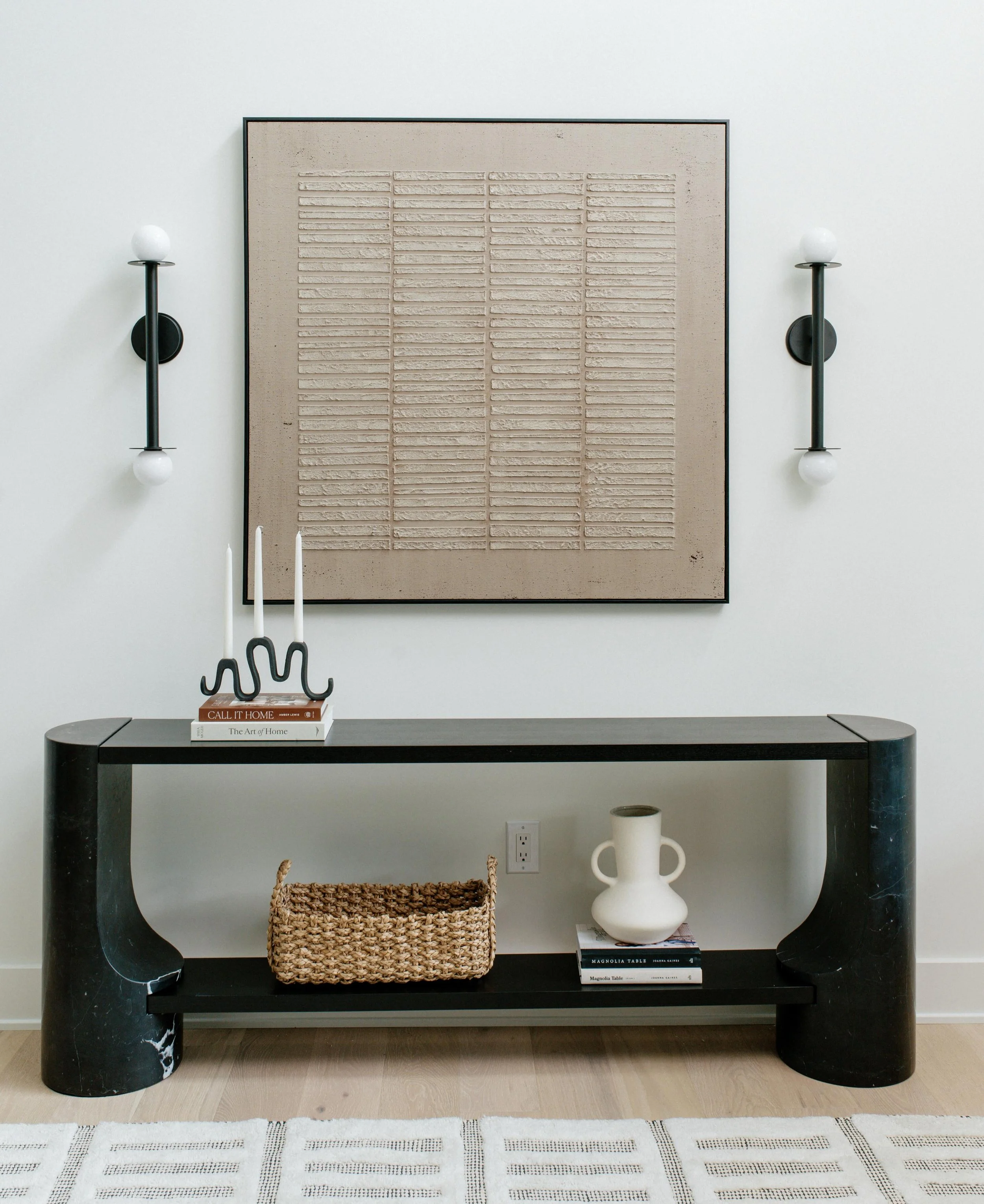 Your entryway is the first thing your guests see, so let it reflect you and your home in the best way ✨ We added sconces to this space for layered lighting and love the textures and shapes that we curated for this clients entry! 🤍 

#entryway #earth