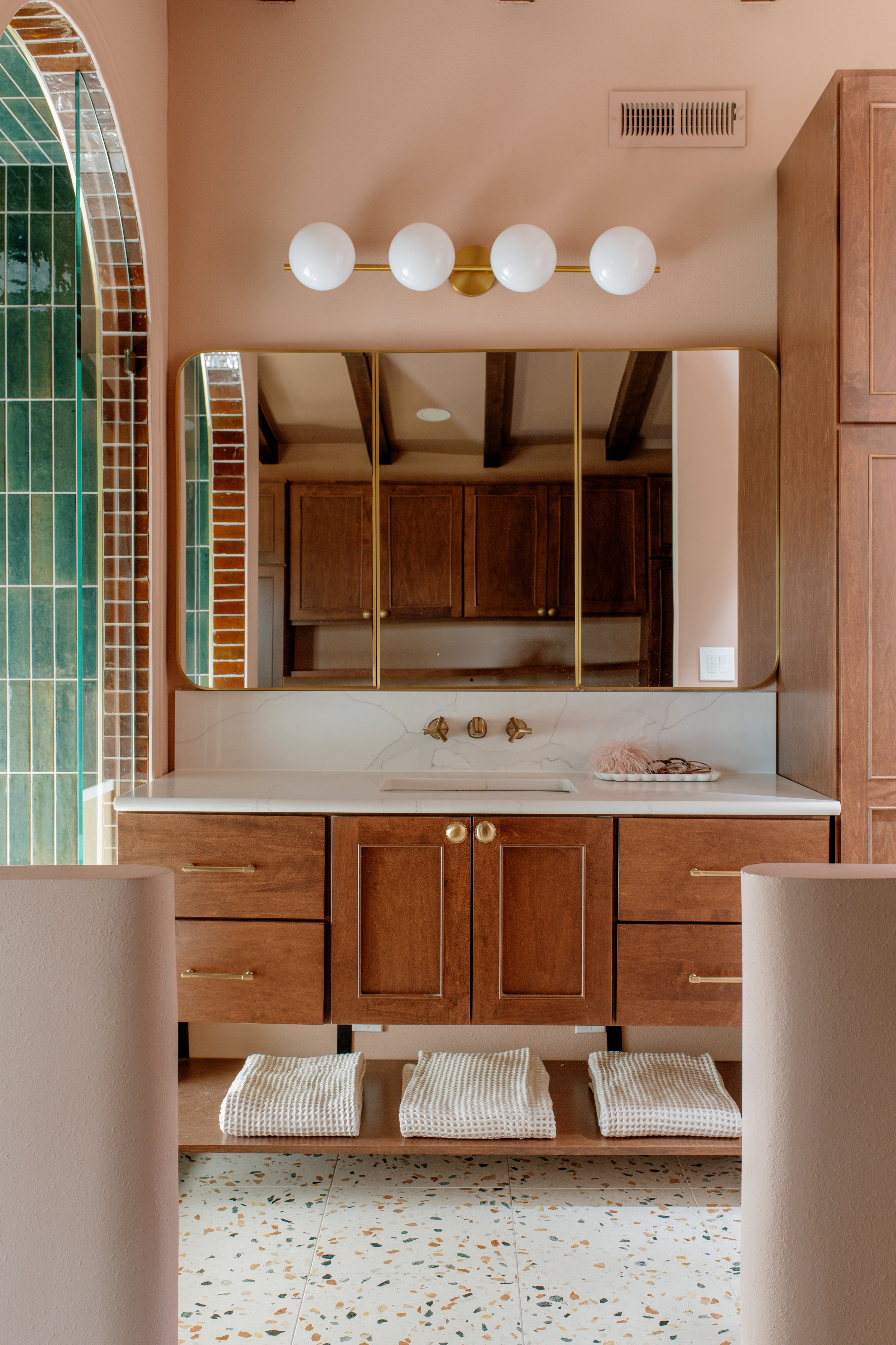 The puzzle of the floating vanity, wall mounted faucet, medicine cabinet and lighting all fit together perfectly to create this gorgeous and functional bathroom
