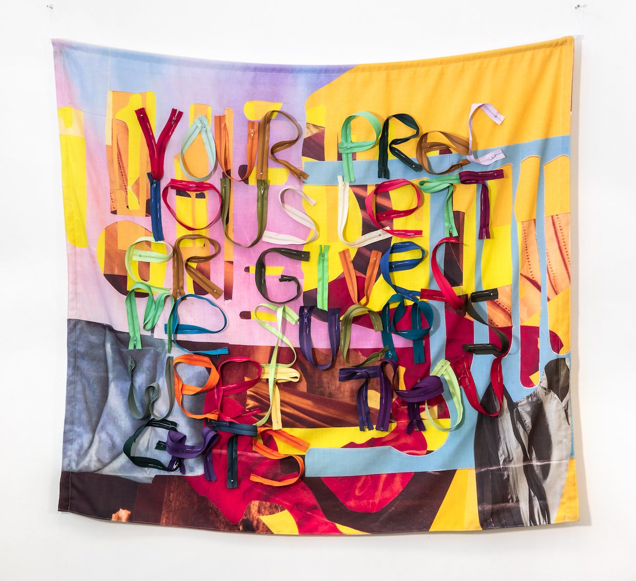 Yellow Shift, 2021, Digital print on fabric, zippers, thread, 48 x 48 x 3-½ inches.

“Yellow Shift” features text from little-known letters from Emily Dickinson to her beloved, Susan
Gilbert that spell out her passionate yearning for time together ac