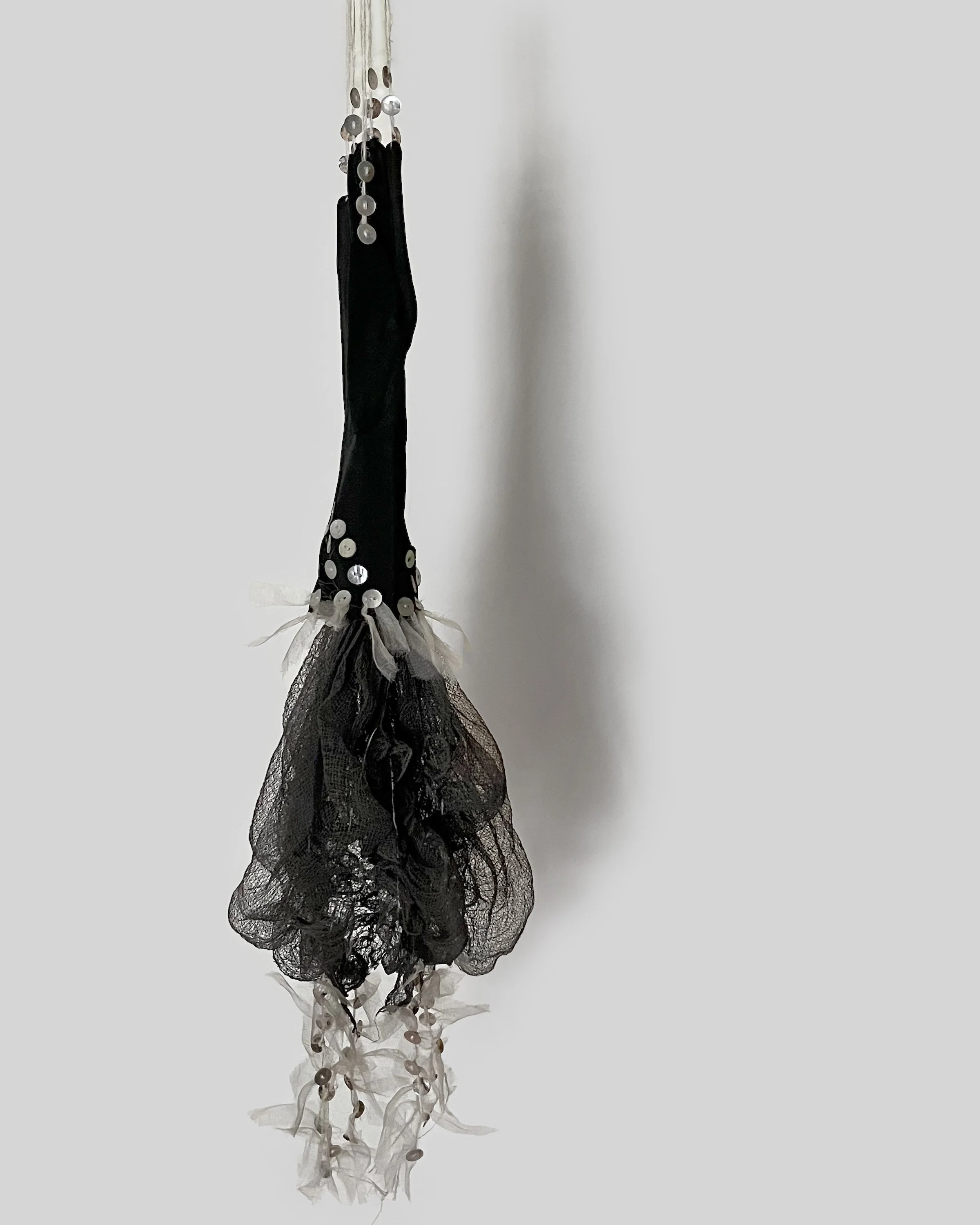 Black Glove  2025  3’ x 6”, Vintage glove, cheesecloth, shell buttons  Dye: iron, $200.