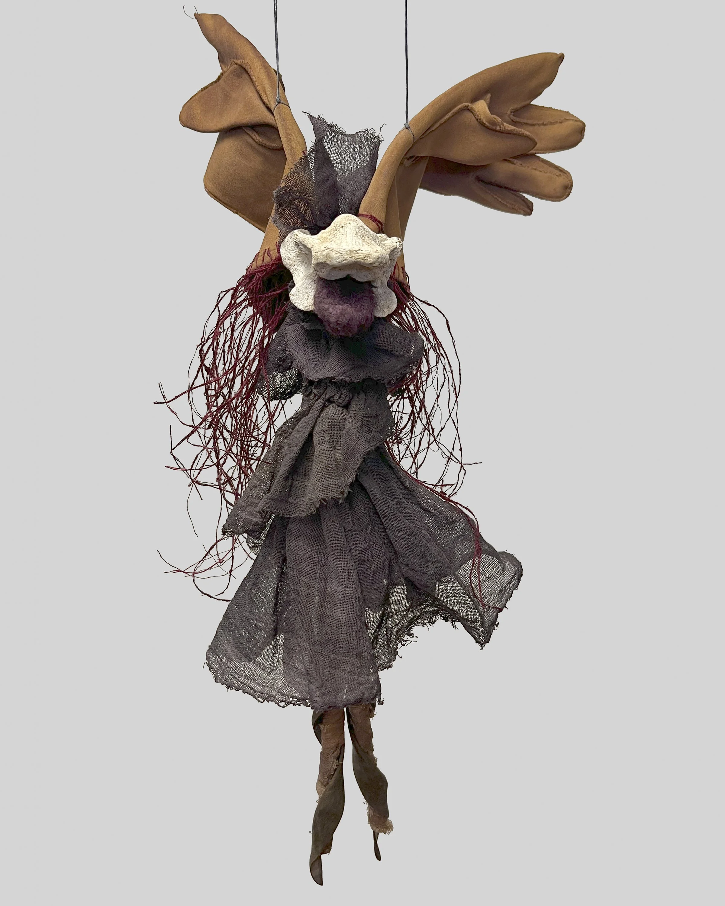 Dark Angel 2  2025 1’9” x 10”d, Cheesecloth, bone, wisteria pods, silk, linen, gloves  Dyes: Cochineal, Redwood cones, iron,  $500.