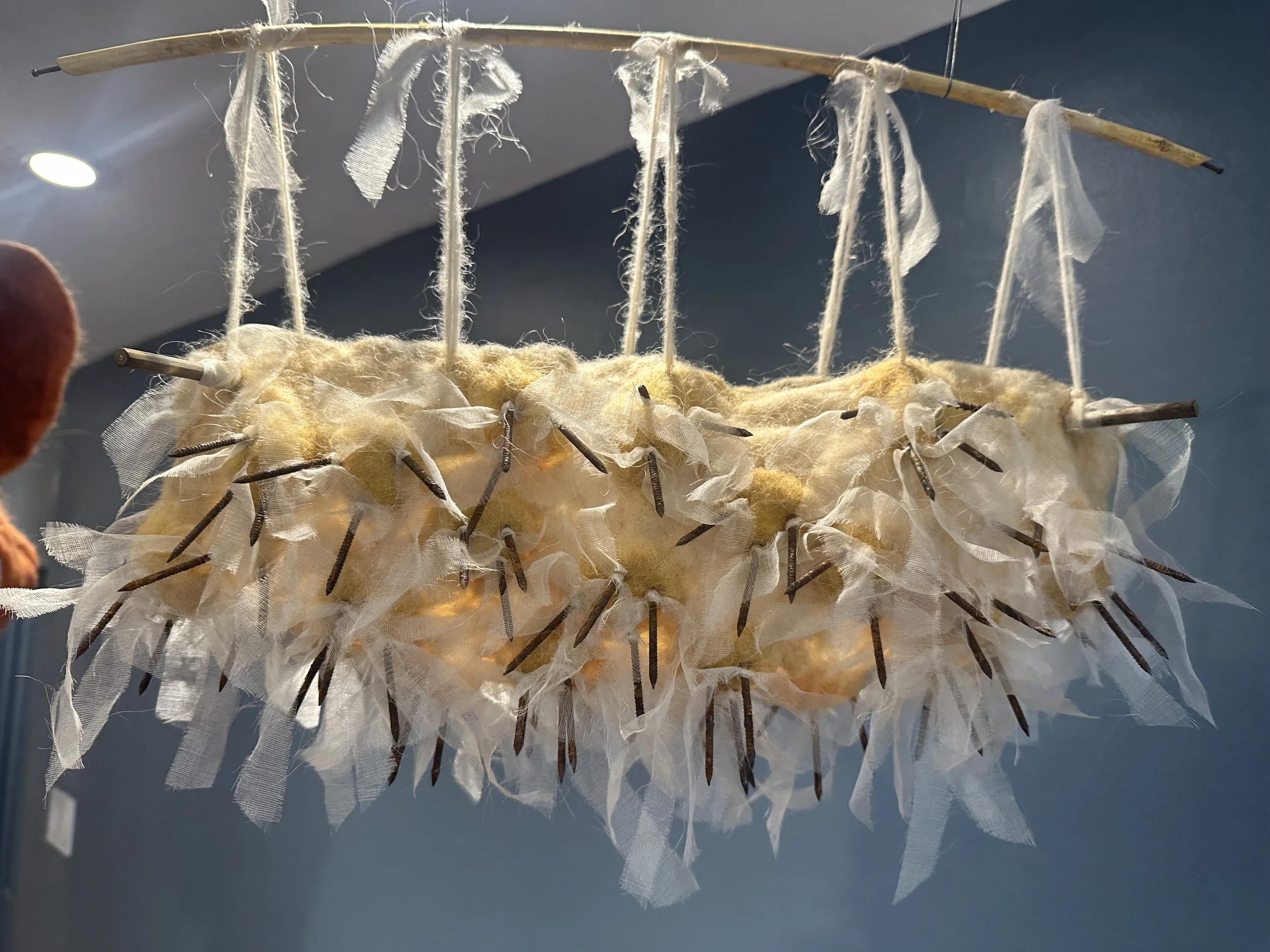 Dangerous Cradle, 2023  1’10”w x 1’3”h  Wool, rusted nails  $800.