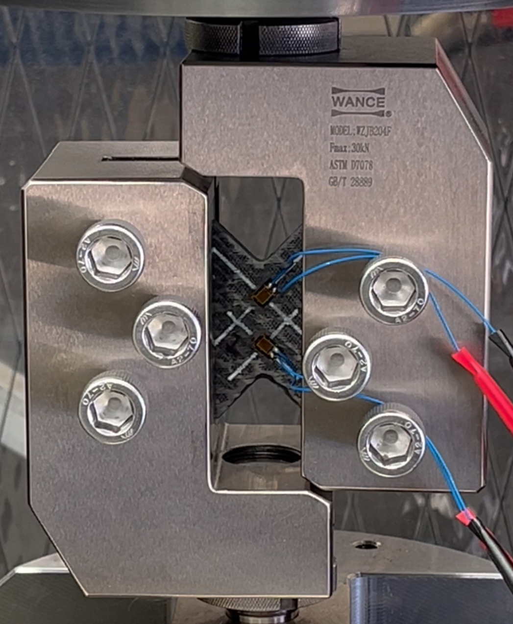 V-notch shear testing of a carbon fibre part, with strain guages attached.