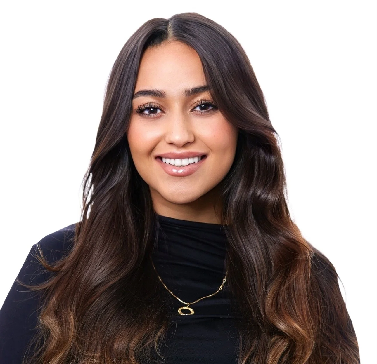 Portrait of a young woman with long wavy brown hair, smiling, wearing a black top and gold jewelry.
