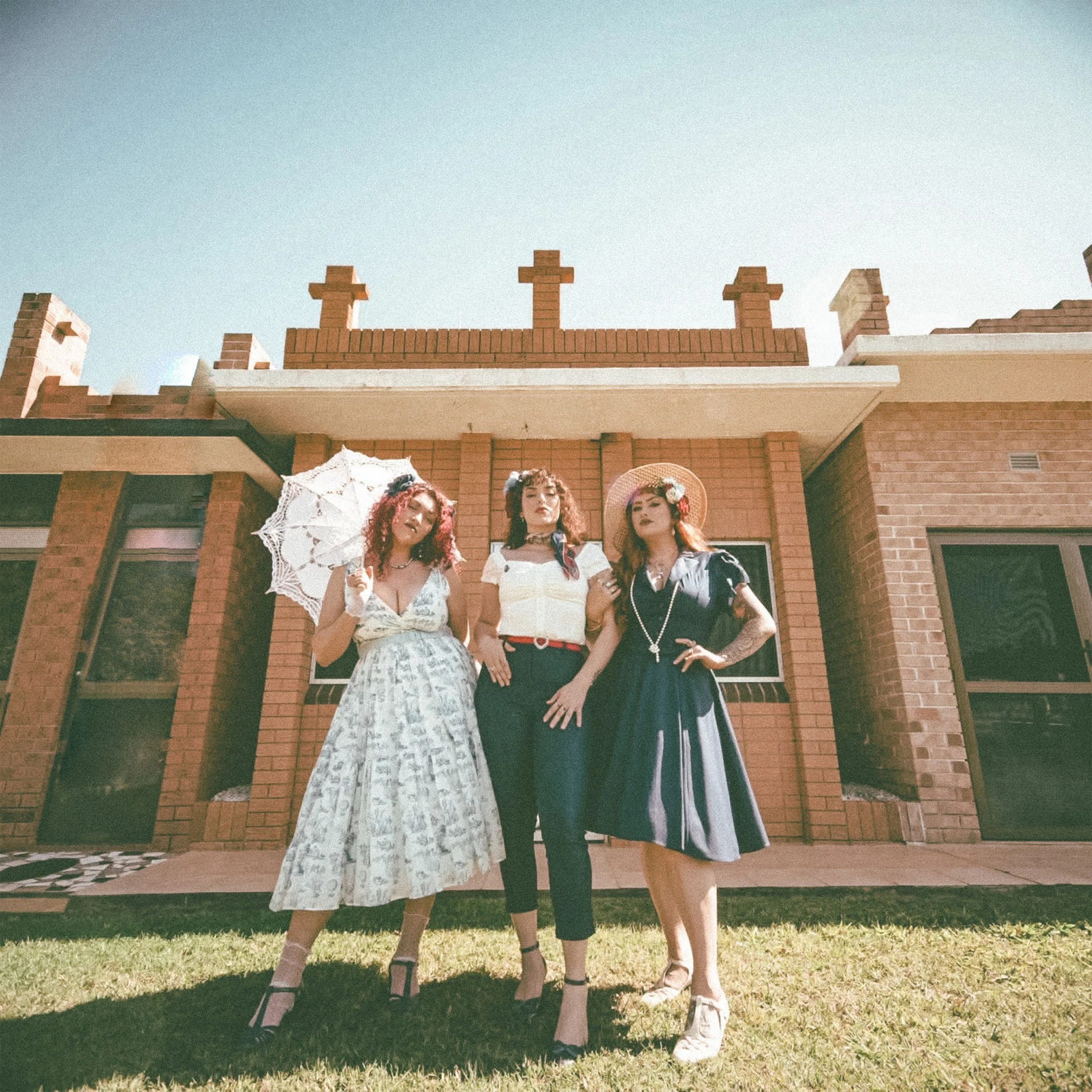 Vixens of Fall stand in front of a mausoleum