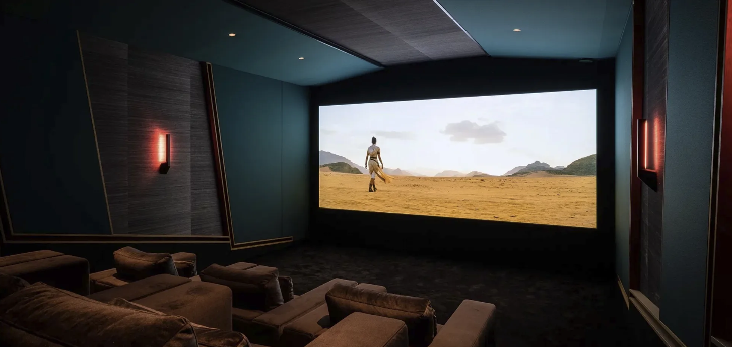 a JBL Synthesis home theater with seating, projection screen, lights, and acoustic wall treatments