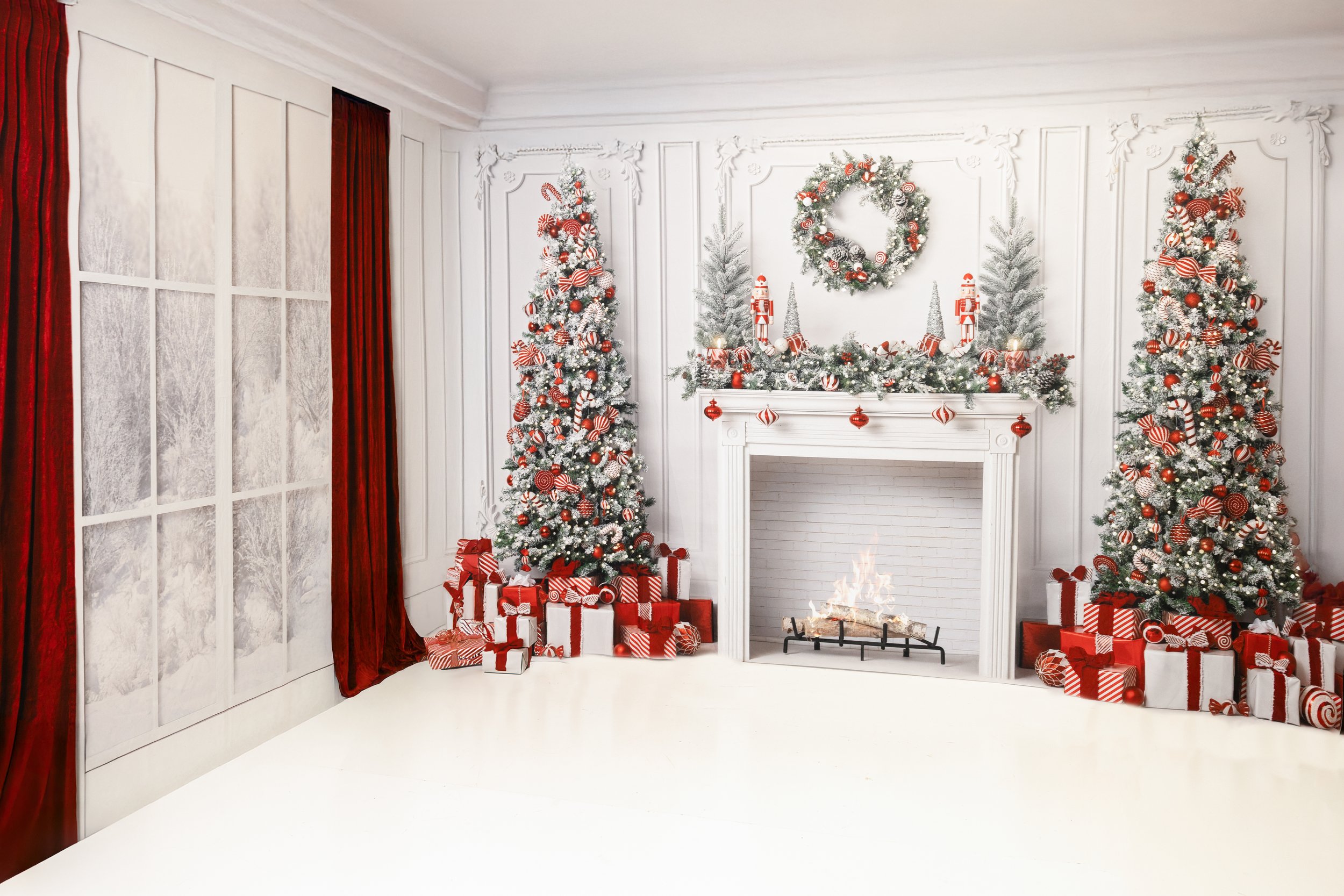 A festive holiday scene in a bright white room with decorated Christmas trees, a fireplace with a fire, wrapped presents, and holiday ornaments, all in red, white, and green colors.