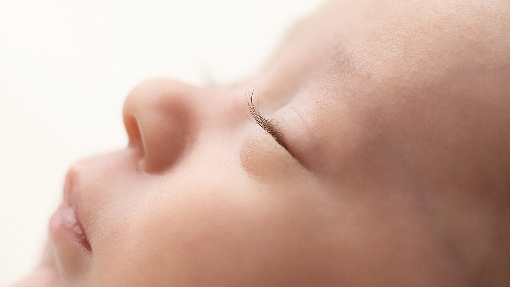 Professional newborn photography close-up of baby’s eyelashes