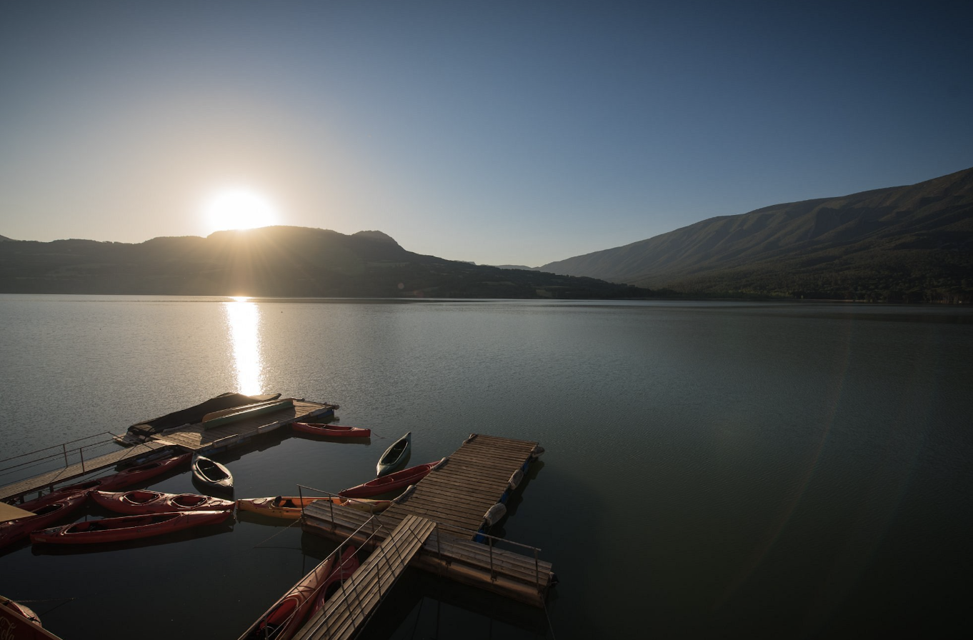 Outdoor activity holidays - Serene Terredets Lake with kayaks and a picturesque sunset, capturing the tranquil ambiance and outdoor activities enjoyed on our tours