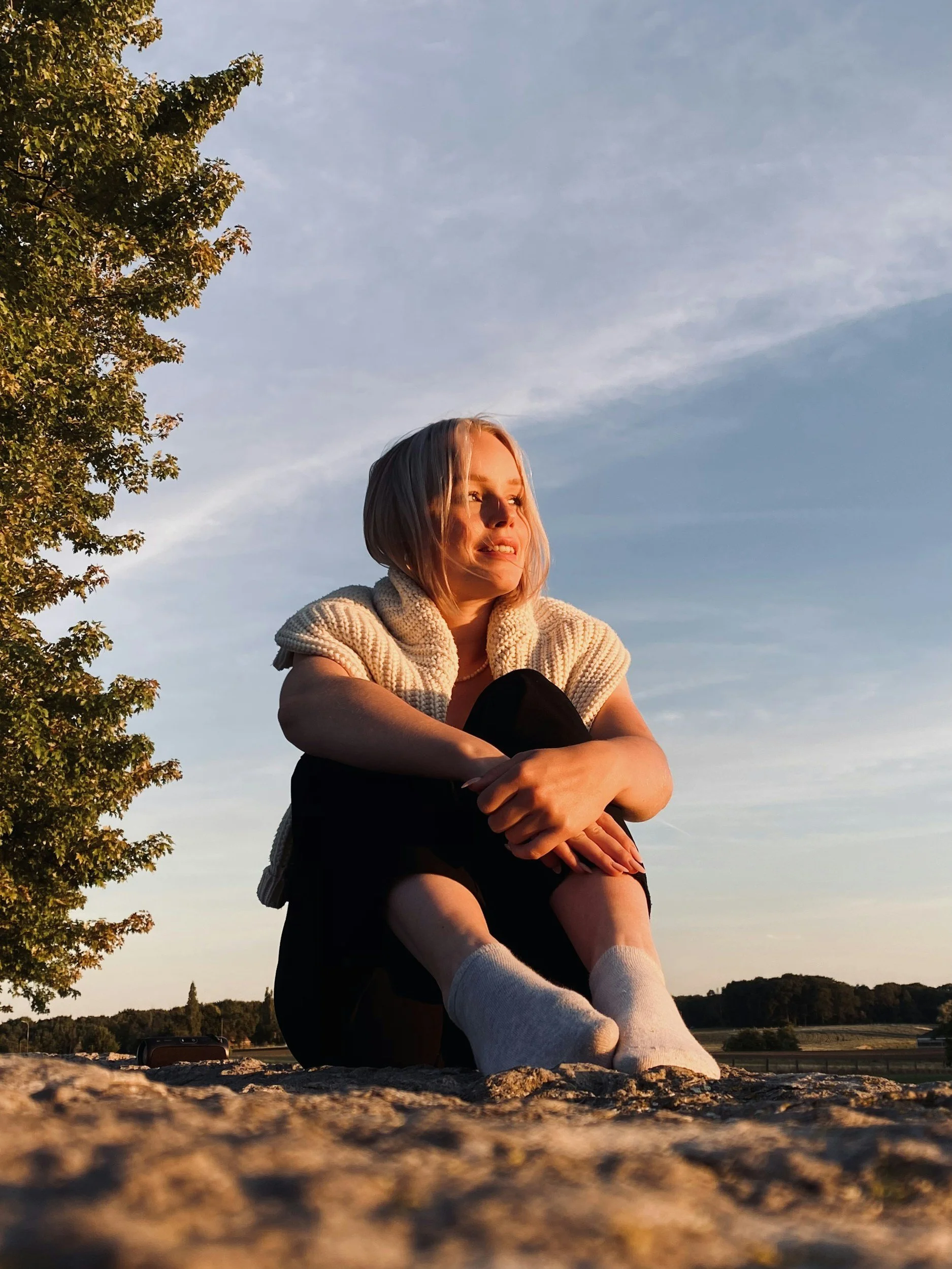 Woman sitting in nature looking into the distance