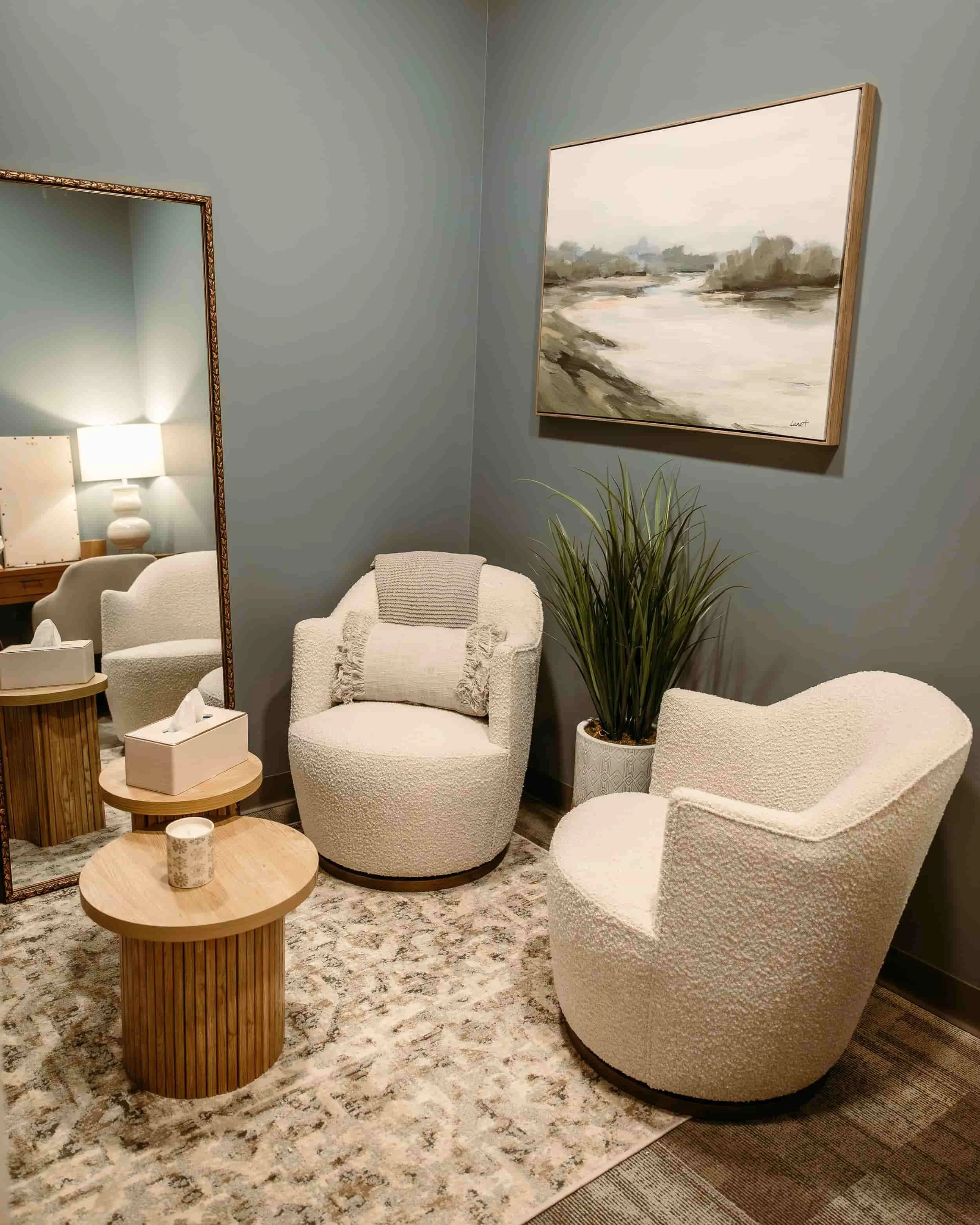 A sitting room at the Balanced Wellness office with two comfy chairs and a coffee table with tissues and a candle.