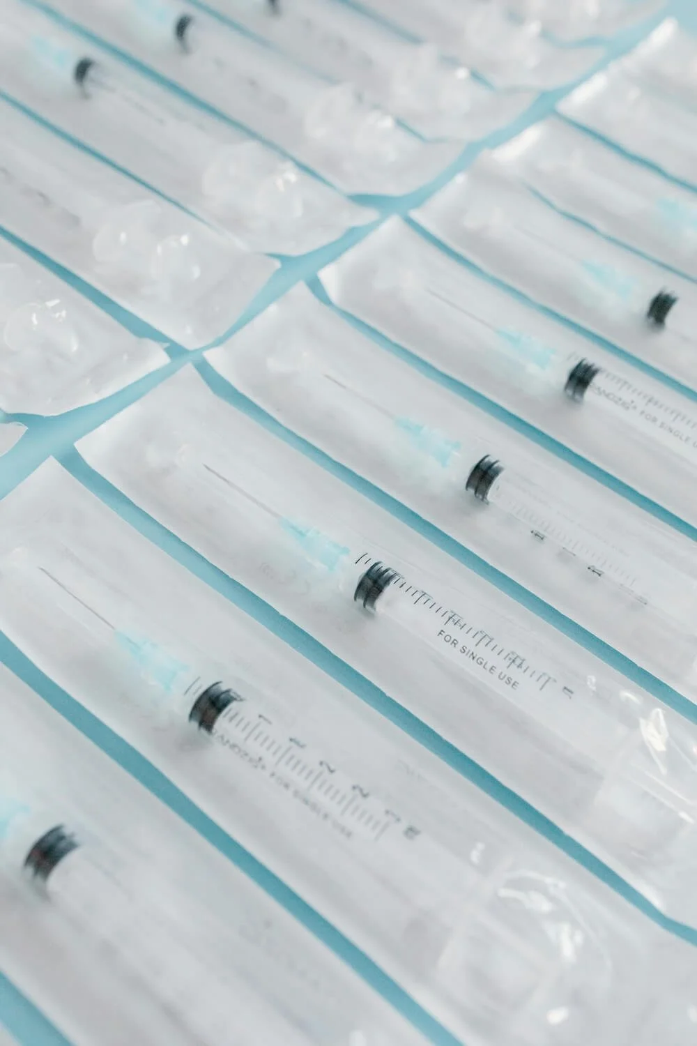 a bunch of single use fertility needles lined up.