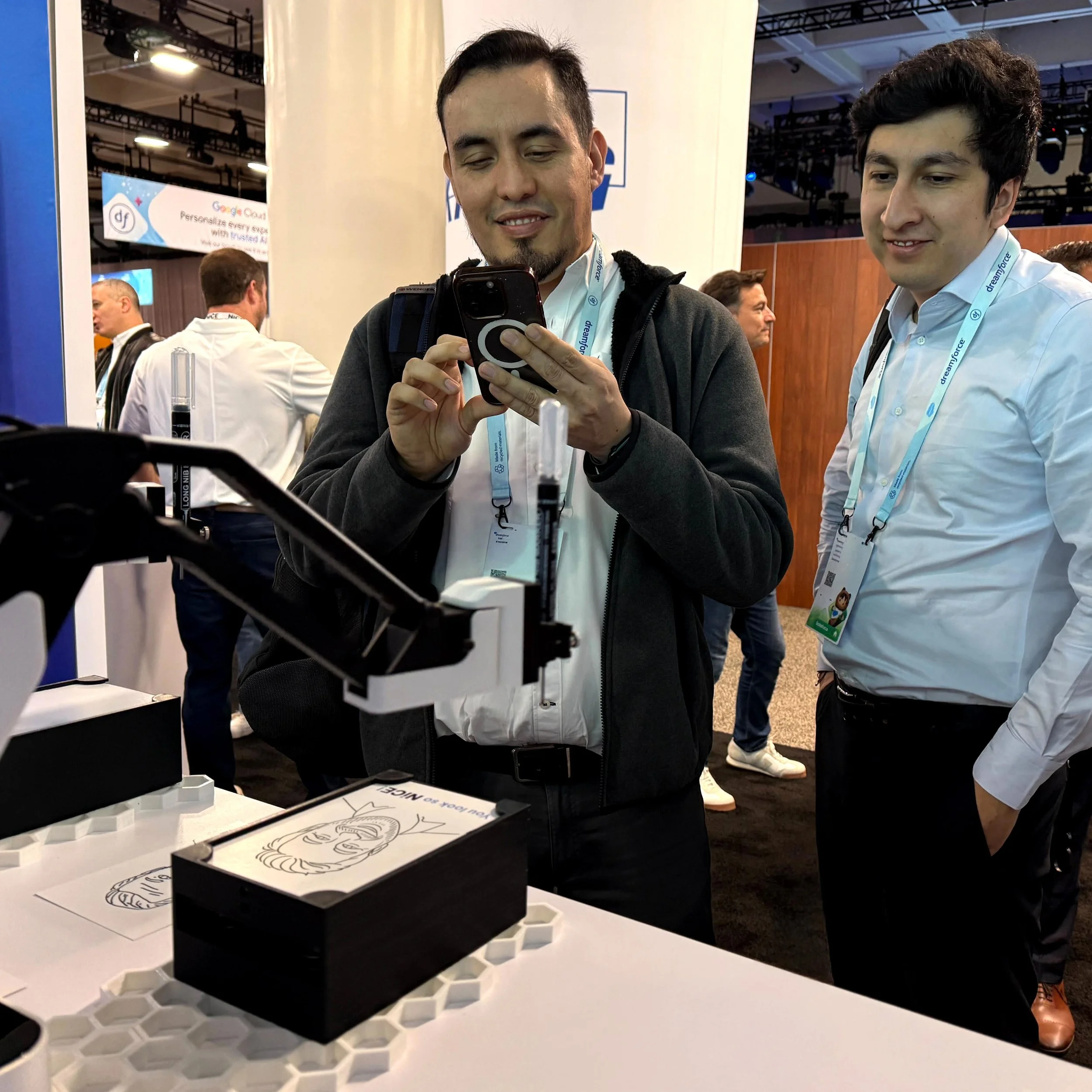 Guests recording as the SketchBot draws their portrait