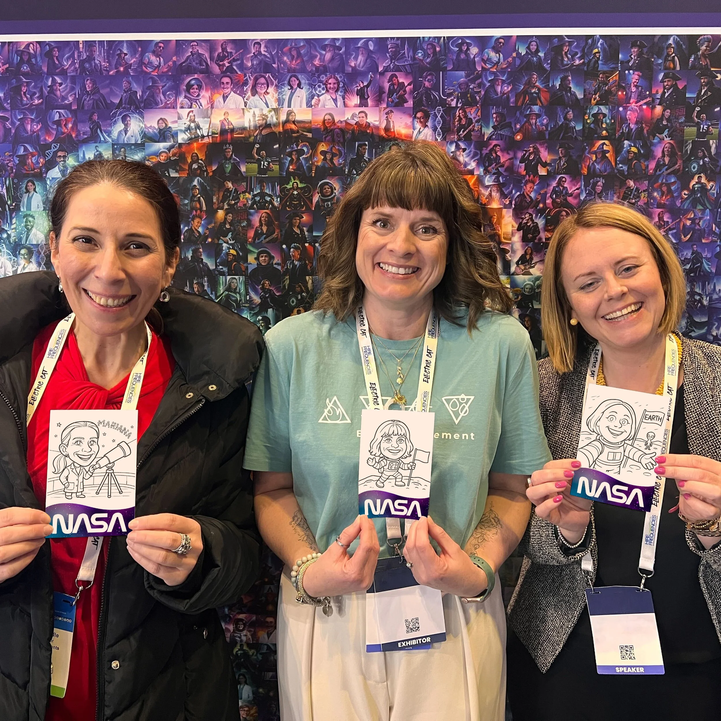 Three women holding up their spaced theme caricatures drawn by the sketching robot
