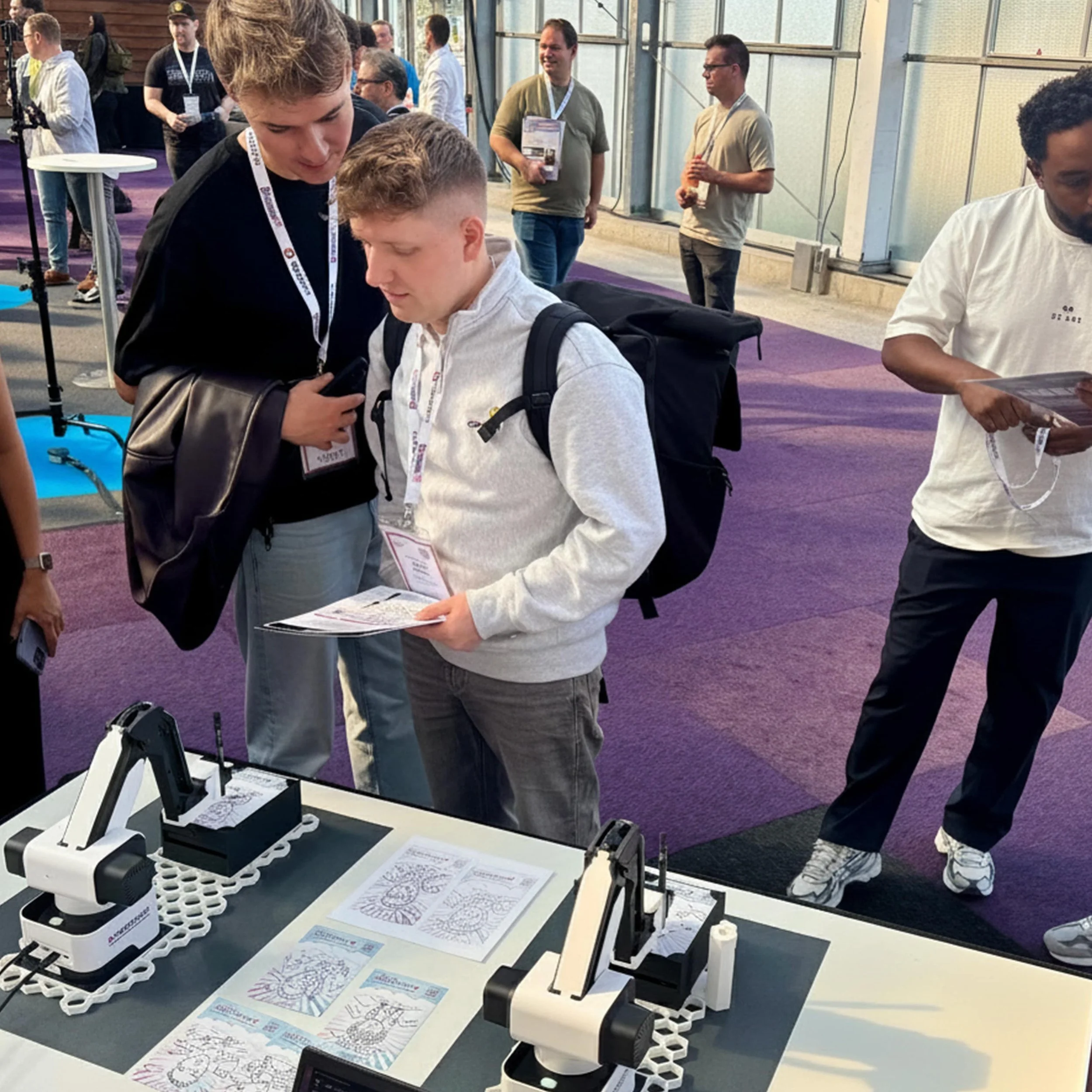Booth with several SketchBots on a table, ready to draw