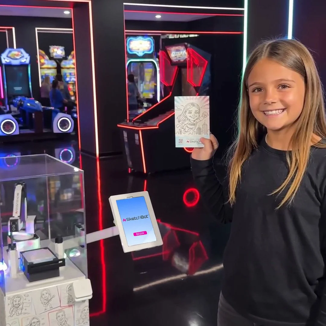 A girl holding up her robotic drawn sketch she got done while at an arcade